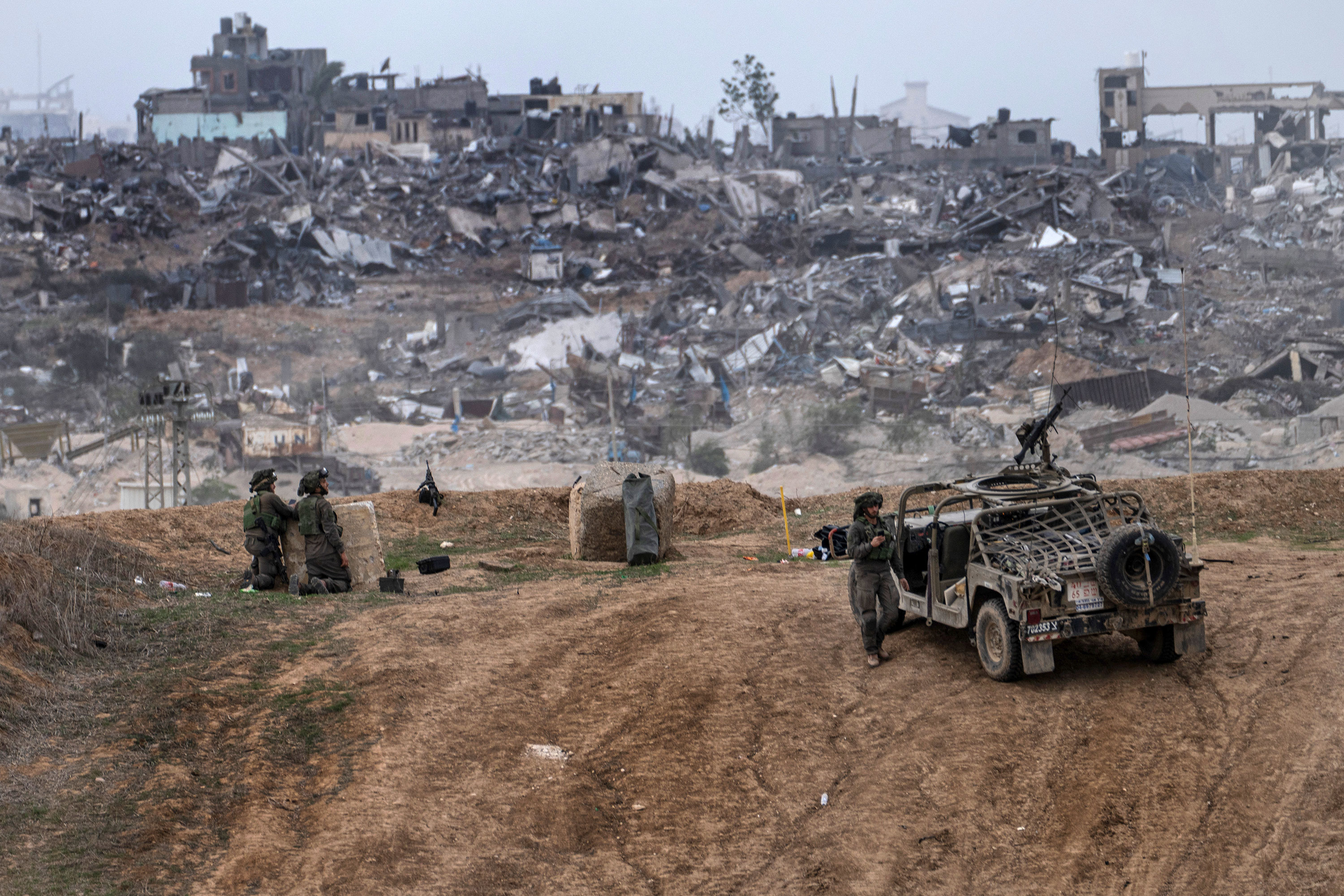 Israeli army vehicles and soldiers are seen near the border with Gaza, in southern Israel, on December 23. 