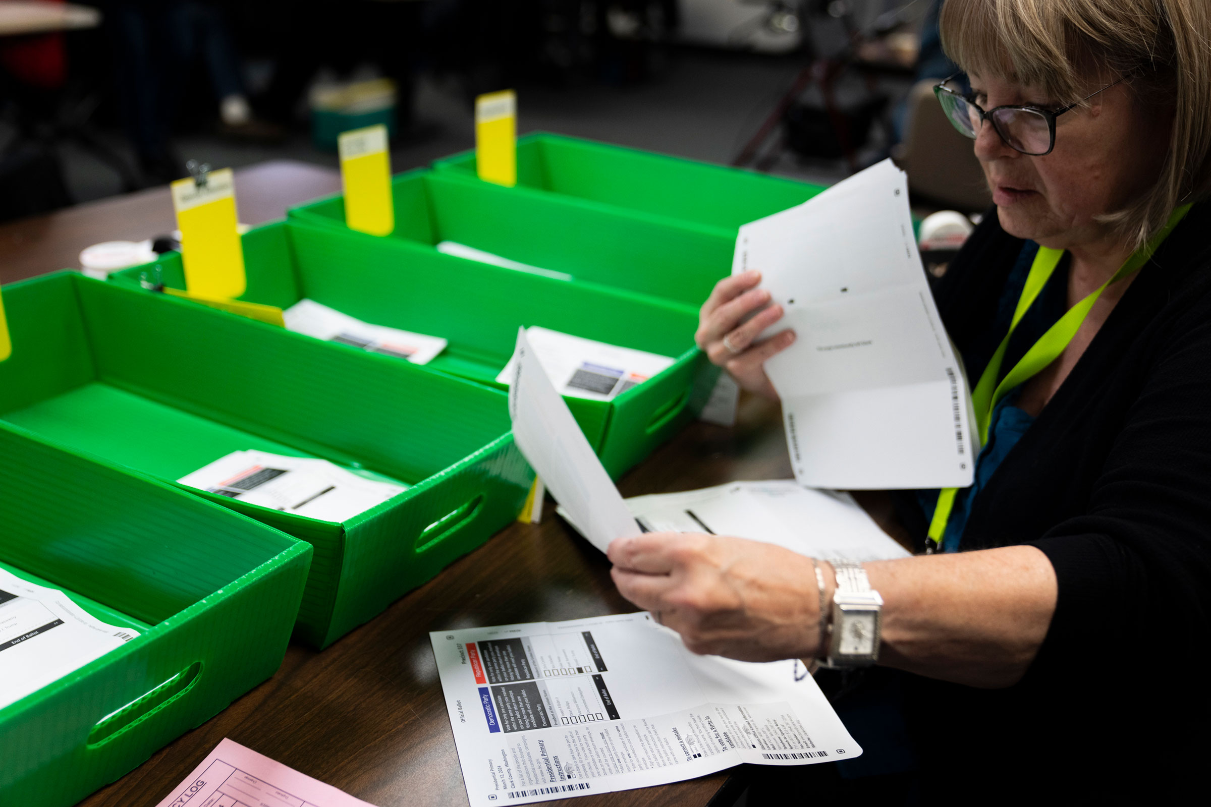 An election worker sorts through vote-by-mail ballots on Tuesday in Vancouver, Washington.
