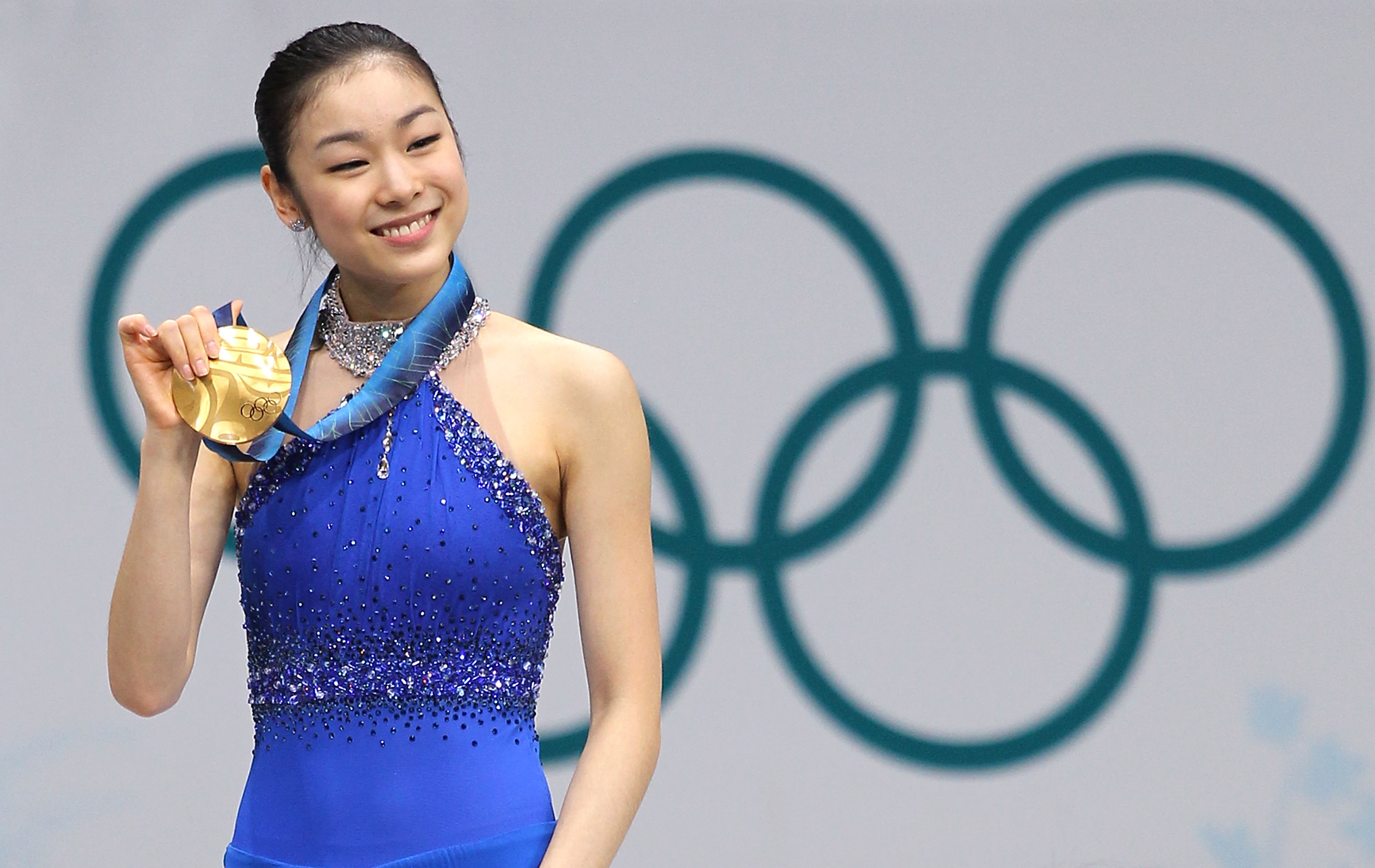 South Korea's Kim Yuna celebrates winning the gold medal in women's singles figure skating during the medal ceremony at the 2010 Vancouver Winter Olympics.