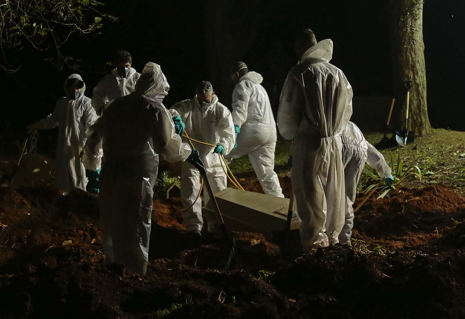 A coffin is buried at the Vila Formosa cemetery in Sao Paulo, Brazil, on March 31.