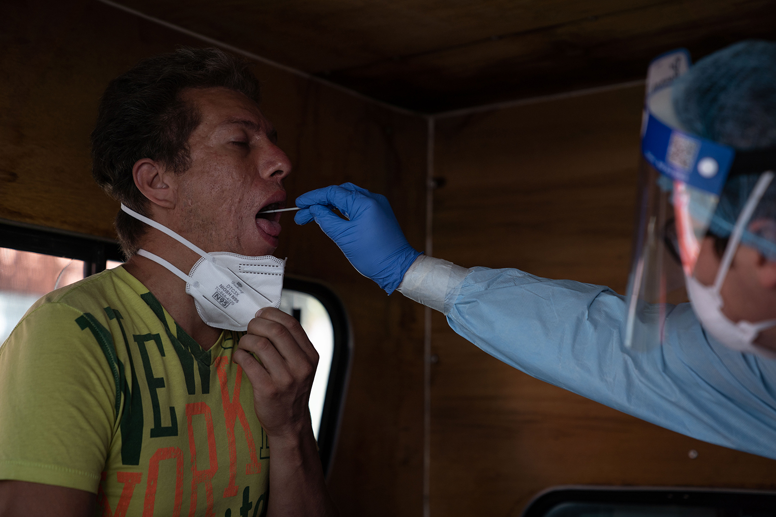 A health worker tests a man for Covid-19 inside a makeshift mobile health station in the Pedregal de Santo Domingo neighborhood on July 17, in Mexico City.