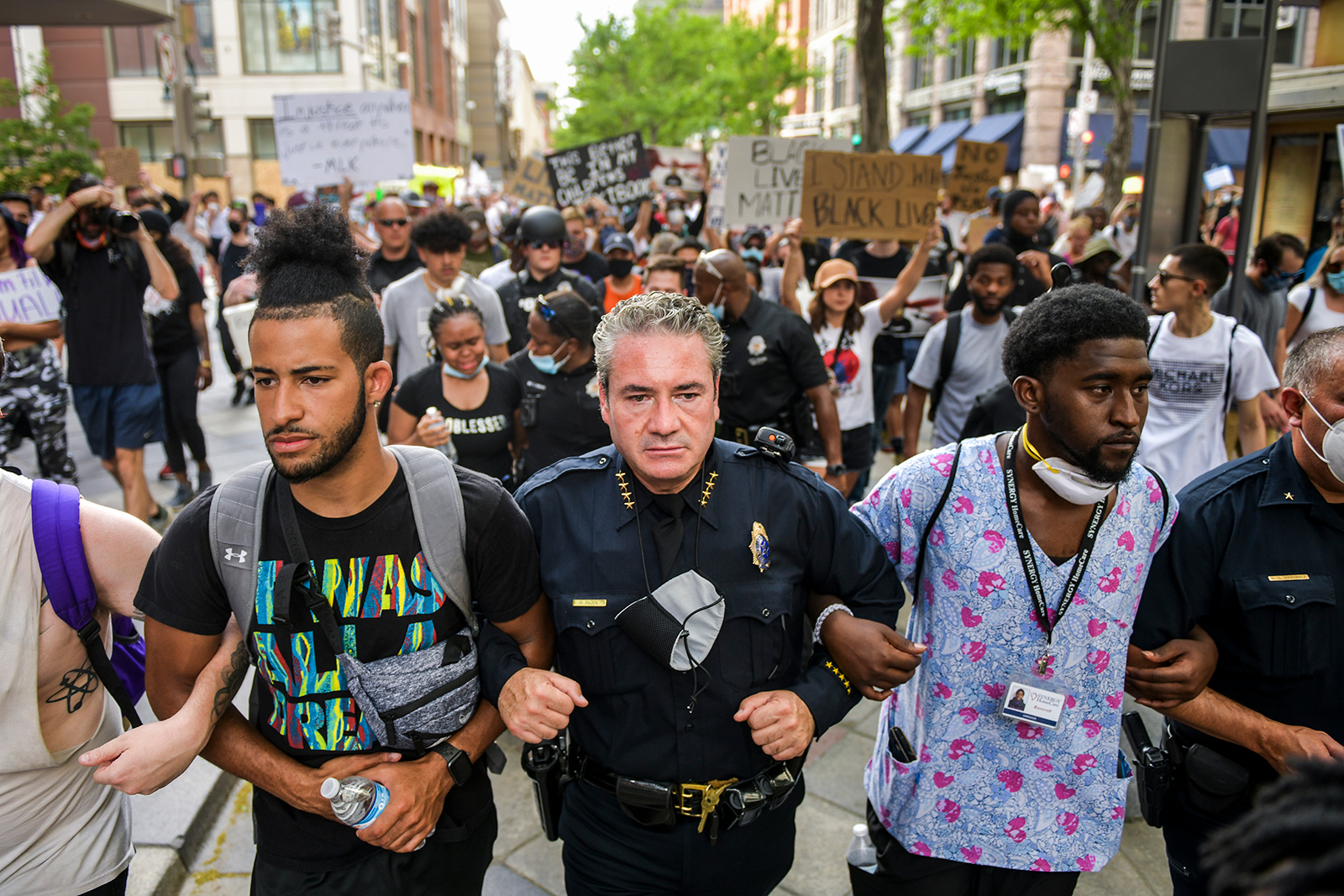 DENVER, CO - JUNE 01: Denver Police Chief Paul Pazen (C) links arms with people protesting the death of George Floyd on June 1, 2020 in Denver, Colorado. 