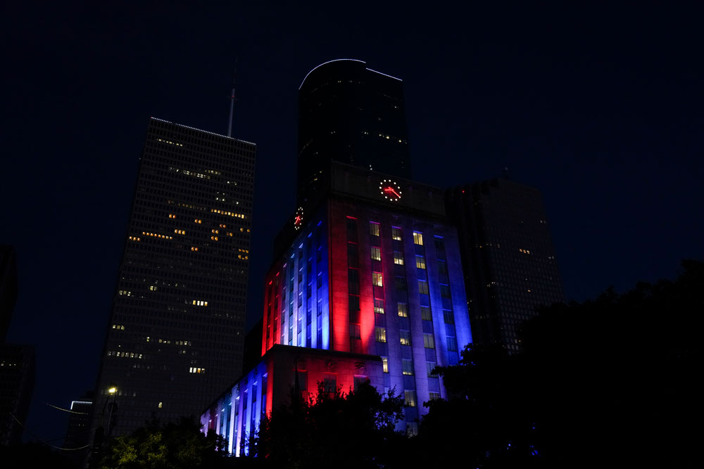 A general view of city hall in downtown Houston, Texas is seen at night, illuminated in colors, in recognition for first responders and health care professionals amid the coronavirus outbreak on Sunday, April 26.