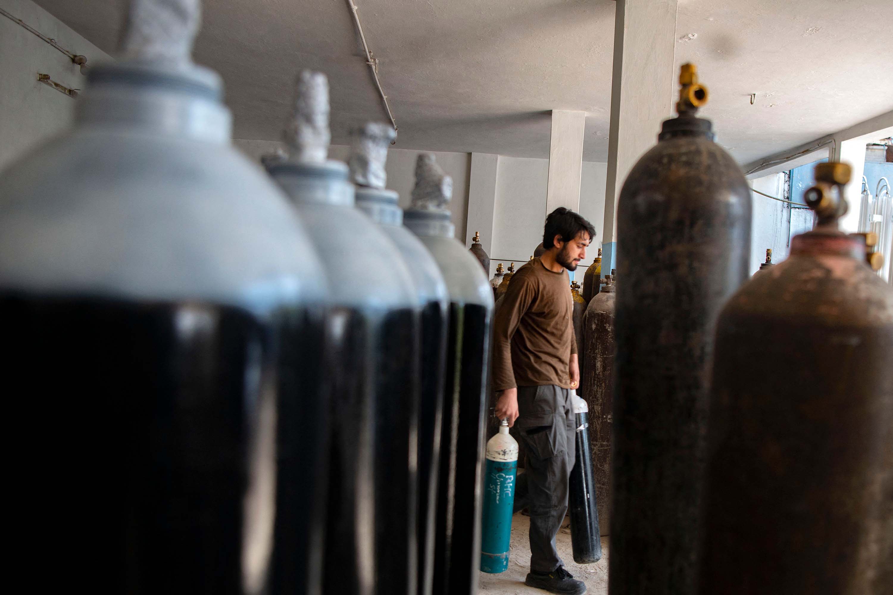 A worker prepares to fill oxygen cylinders for hospital treatment of Covid-19 patients, at a factory in Peshawar, Pakistan, on April 12. 