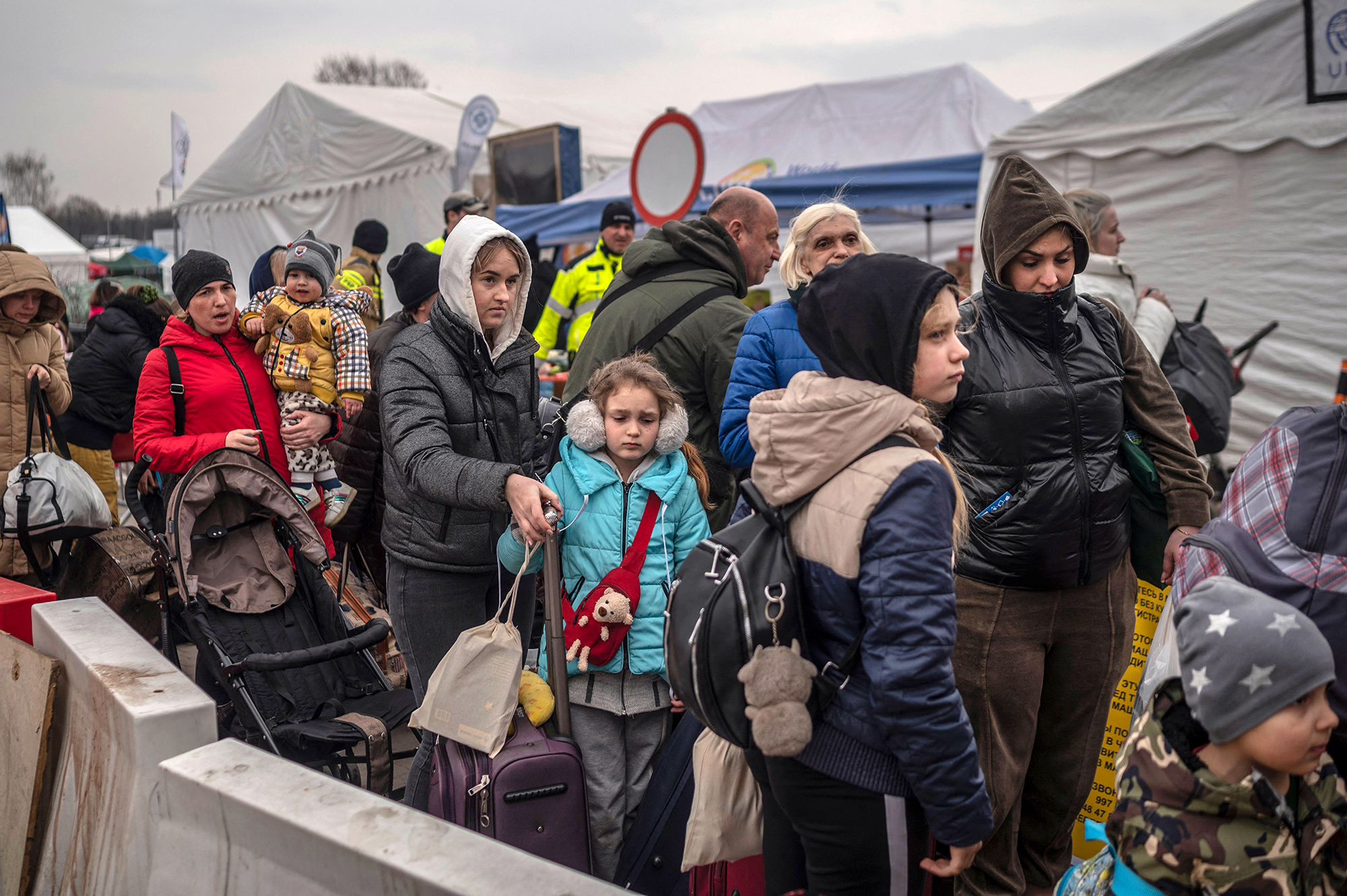Ukrainian evacuees queue as they wait for further transport at the Medyka border crossing in southeastern Poland, on March 29.