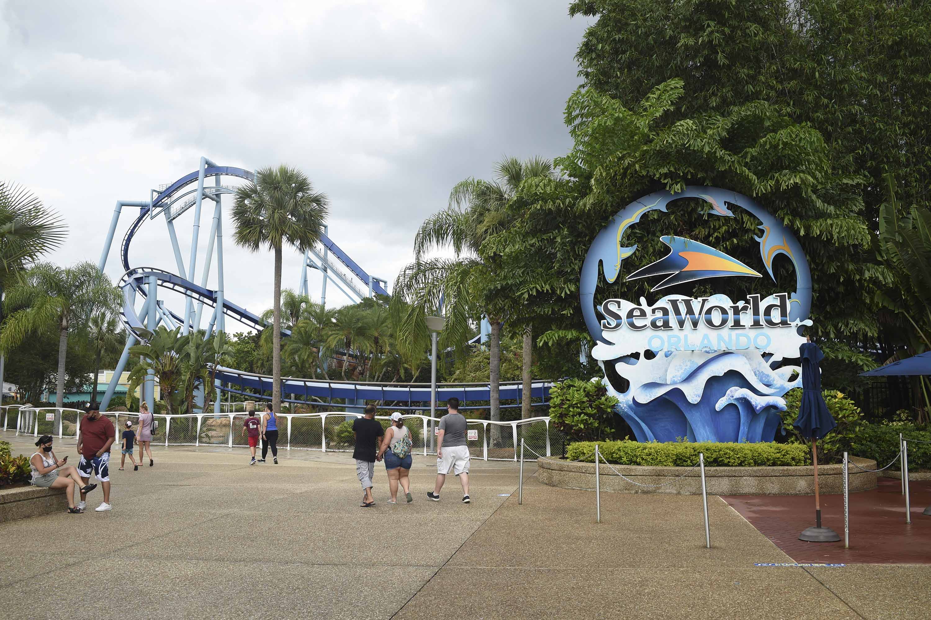 Visitors enter the SeaWorld amusement park in Orlando, Florida, on June 11, following the park's reopening after an almost three-month closure due to the coronavirus pandemic.