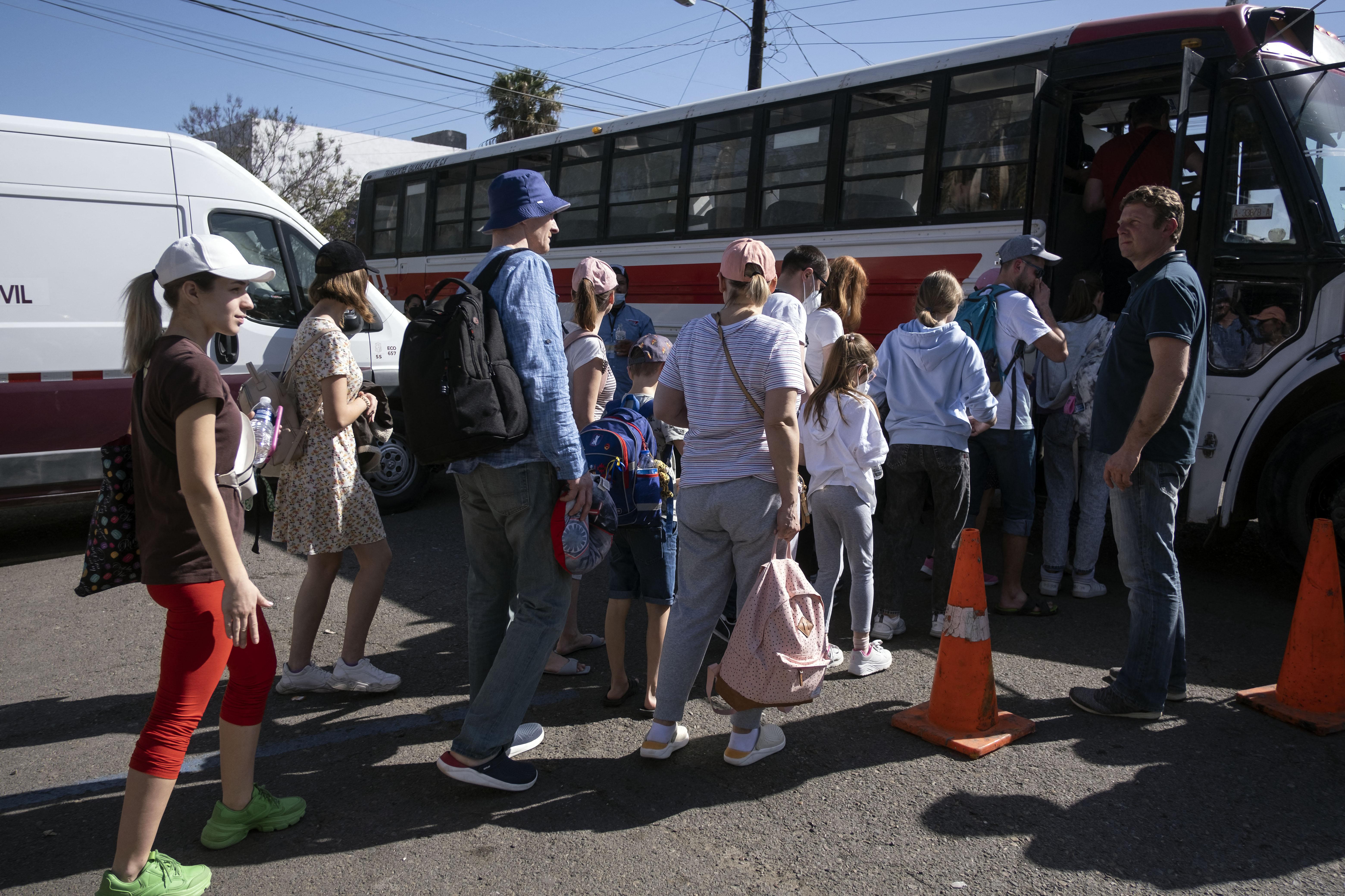 Ukrainians seeking for asylum in the United States board a bus that will go to the border crossing, at the Benito Juarez sports complex in Tijuana, located in the Mexican state of Baja California state, on April 8. 