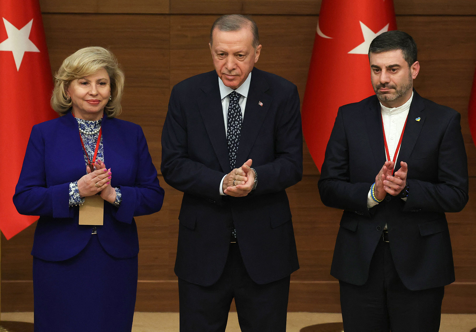 Turkish President Recep Tayyip Erdogan, center, Ukrainian Parliament Commissioner for Human Rights Dmytro Lubinets, right and High Commissioner for Human Rights of the Russian Federation Tatyana Moskalkova applaud as they attend the International Ombudsman Conference at the presidential complex in Ankara, Turkey, on January 11.