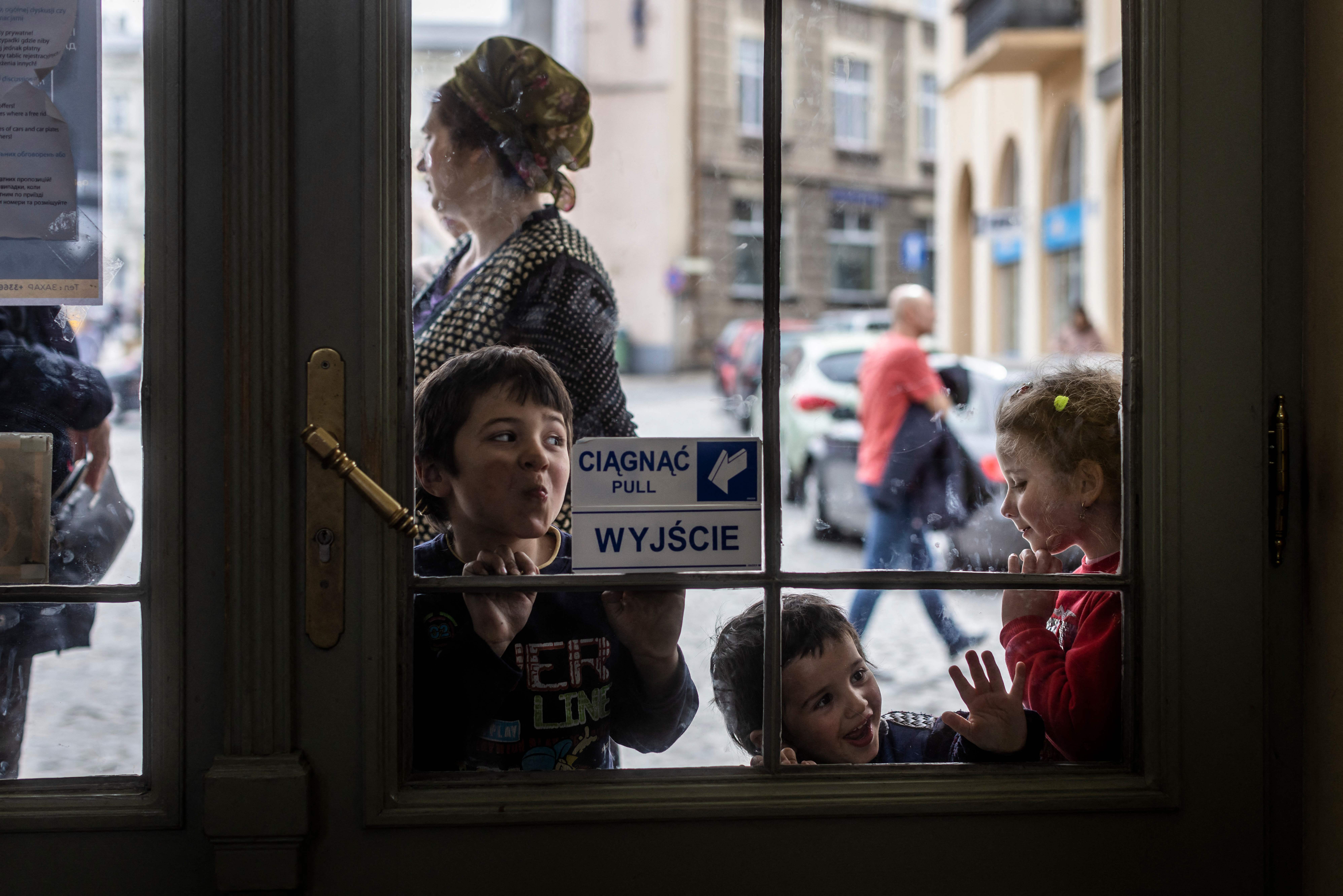 Children play outside of a railway station in Przemysl, eastern Poland, on April 7, which has become a hub for refugees from Ukraine fleeing their country due to the conflict with Russia. 