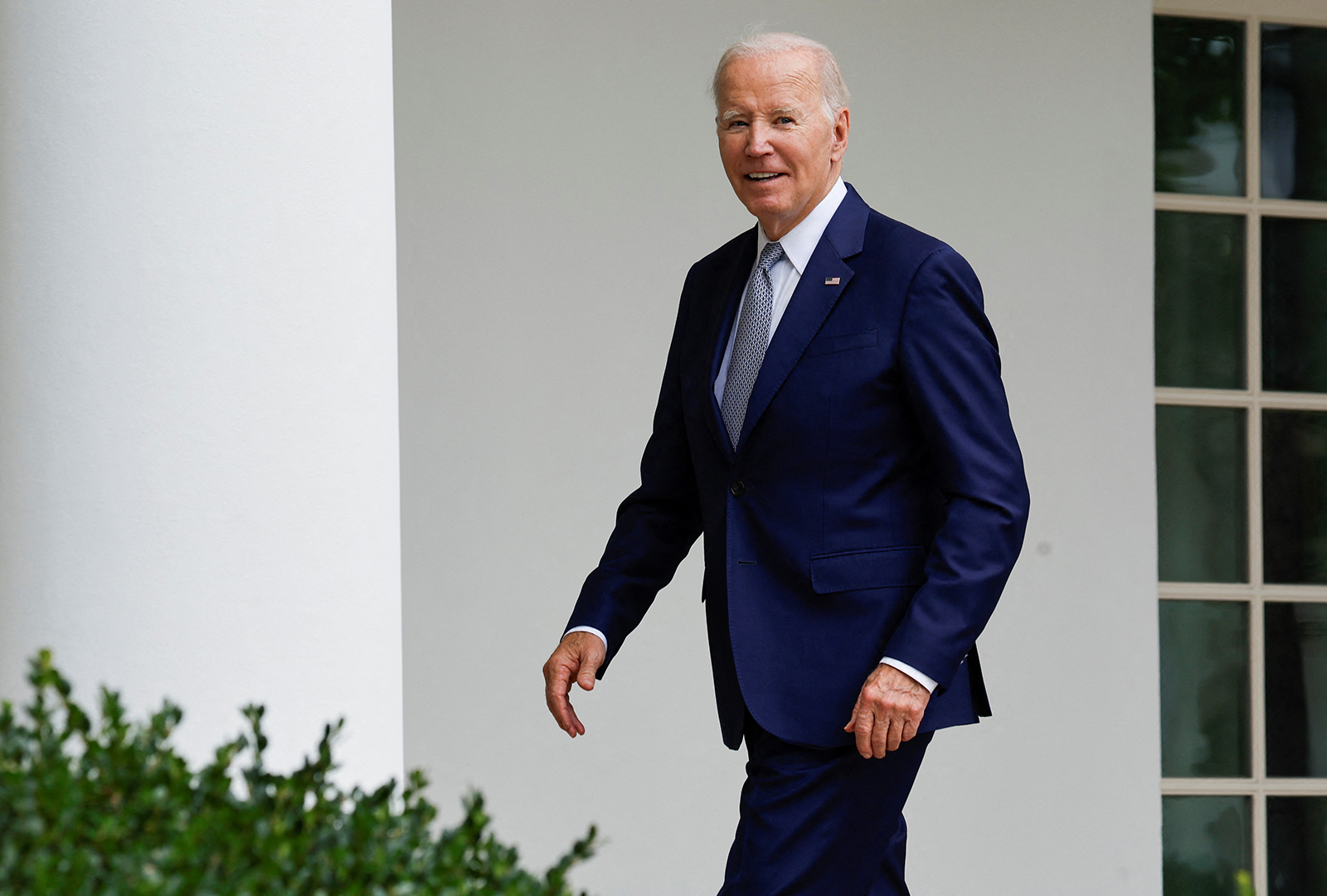 U.S. President Joe Biden smiles as he responds to a reporter's question about whether he will visit striking auto workers on the UAW picket line, as he walks back to the Oval Office after an event announcing the creation of a new White House Office of Gun Violence Prevention, in the Rose Garden of the White House in Washington today.