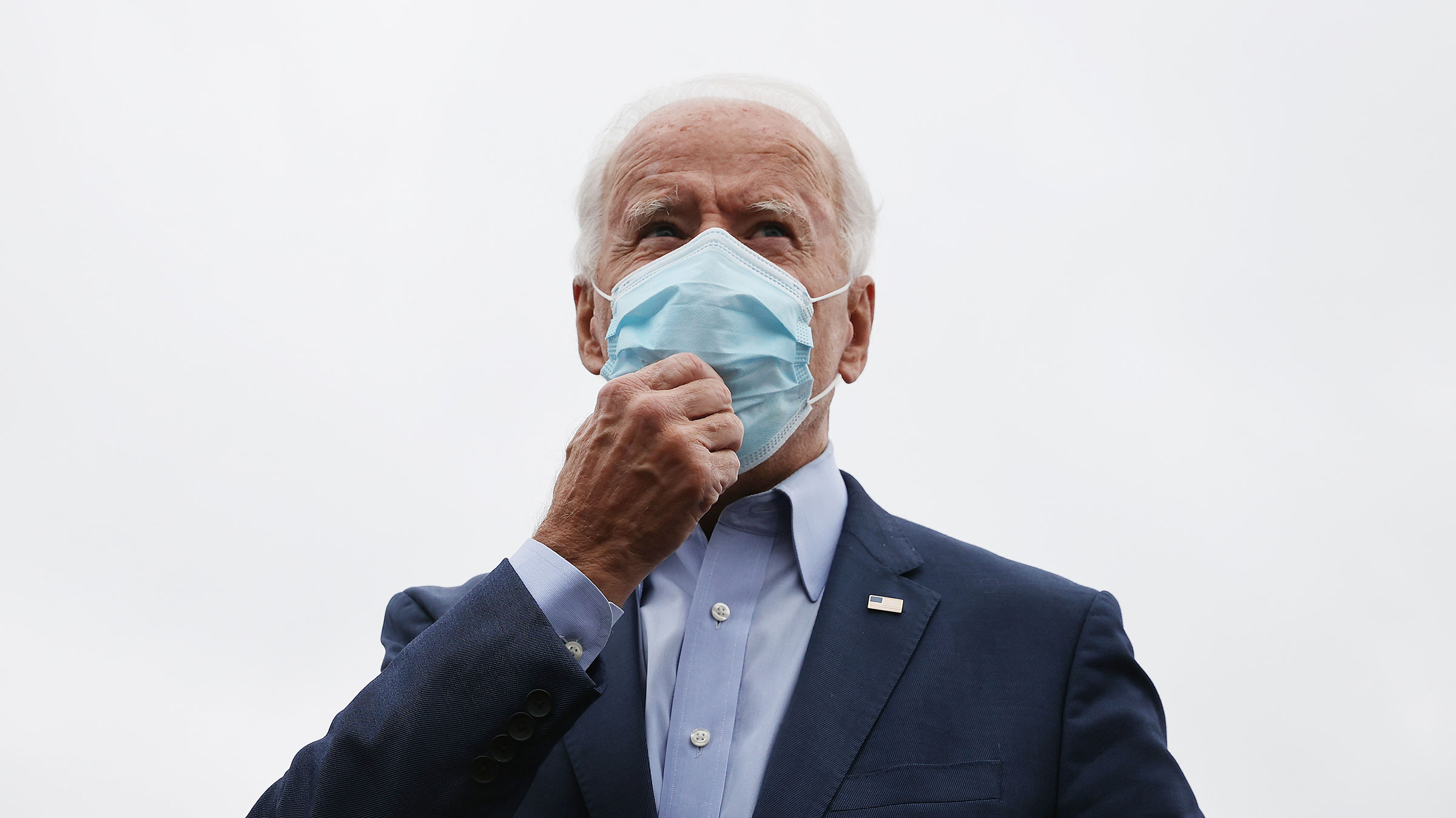 Democratic presidential nominee Joe Biden talks to reporters before boarding a flight to Ohio on October 12 in New Castle, Delaware. 