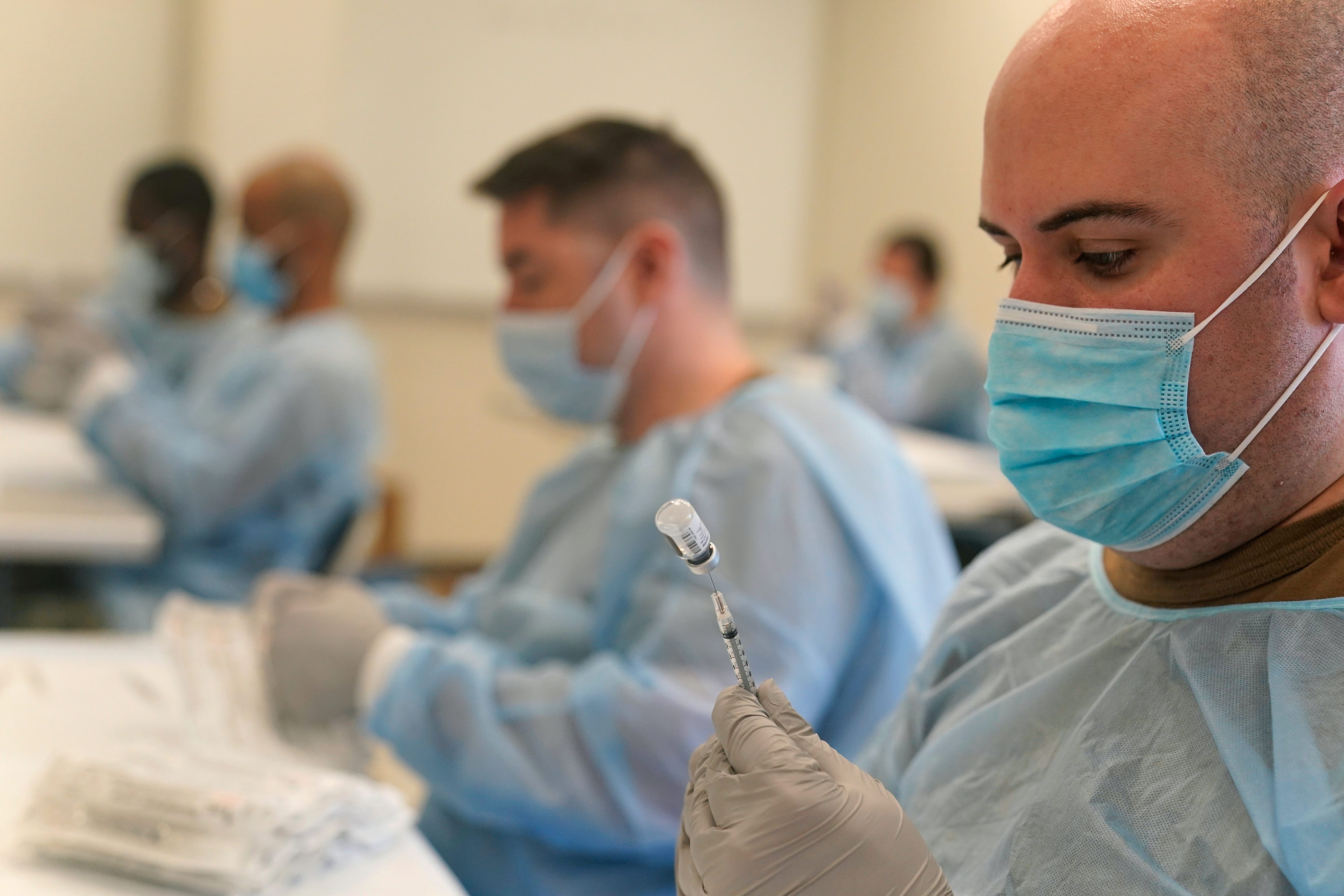 Navy personnel prepare doses of the Covid-19 vaccine at a mass vaccination site in New York, on February 24. 