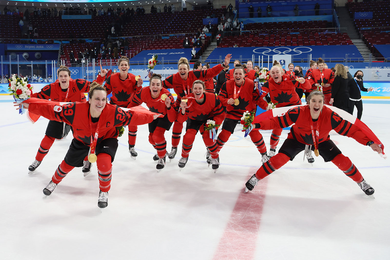 Players from Canada's women's hockey team celebrate with their gold medals after defeating the United States on February 17.
