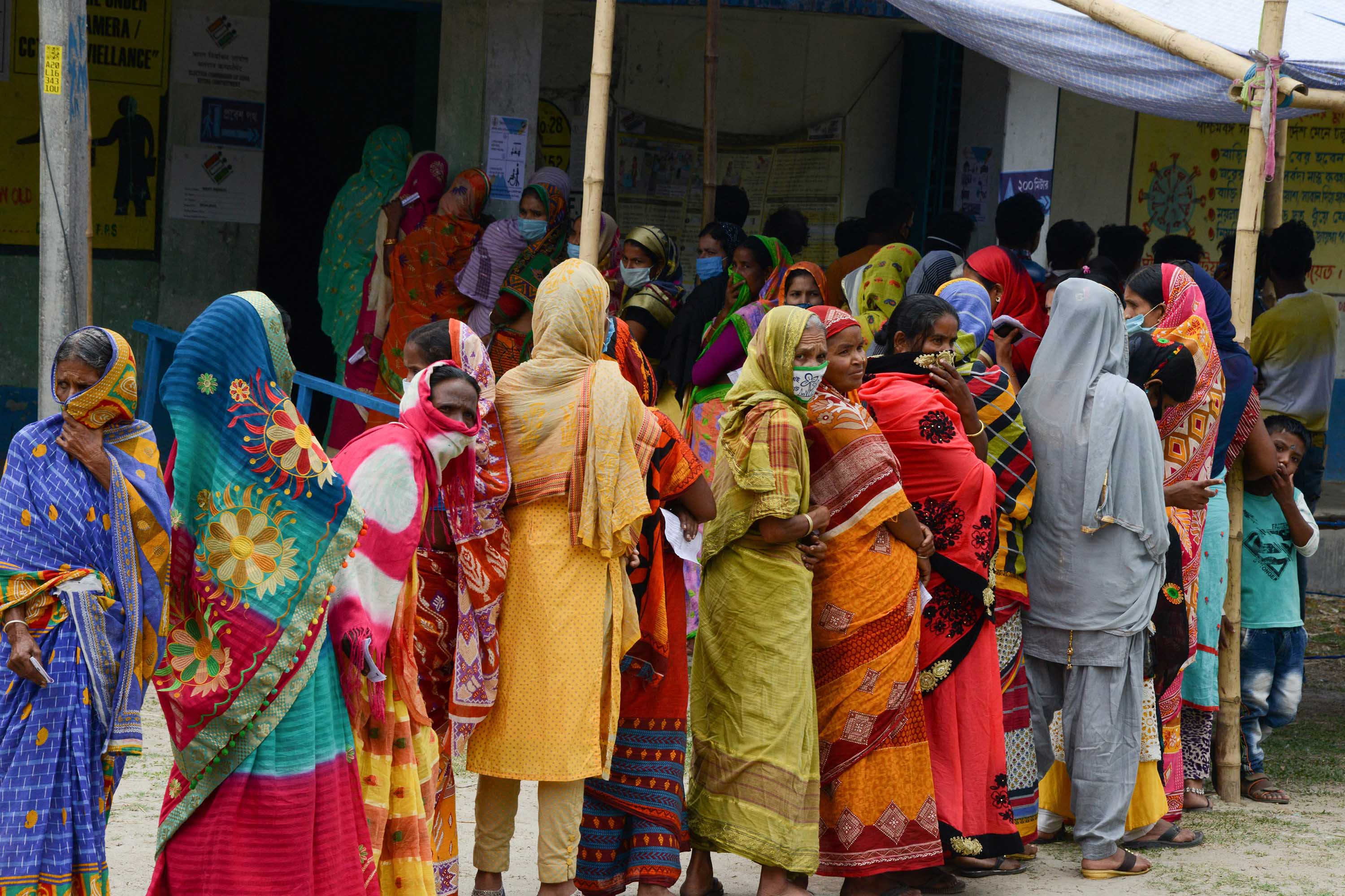 People queue to caste their votes during the 6th phase of the legislative assembly election at Boknabandha village, in India's Dinajpur district, on April 22. 