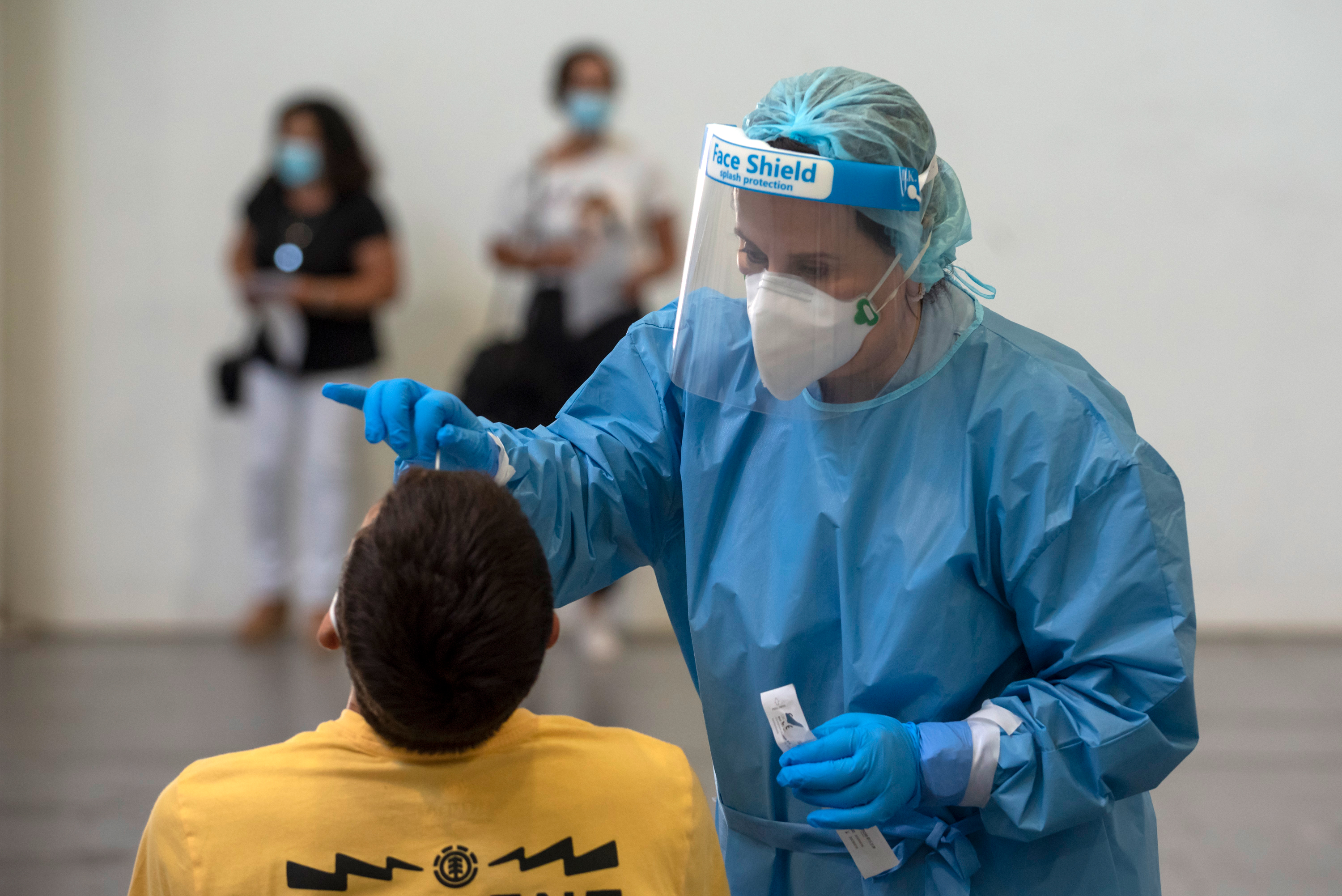 A health worker in Irun, Spain, tests someone for Covid-19 on September 2.