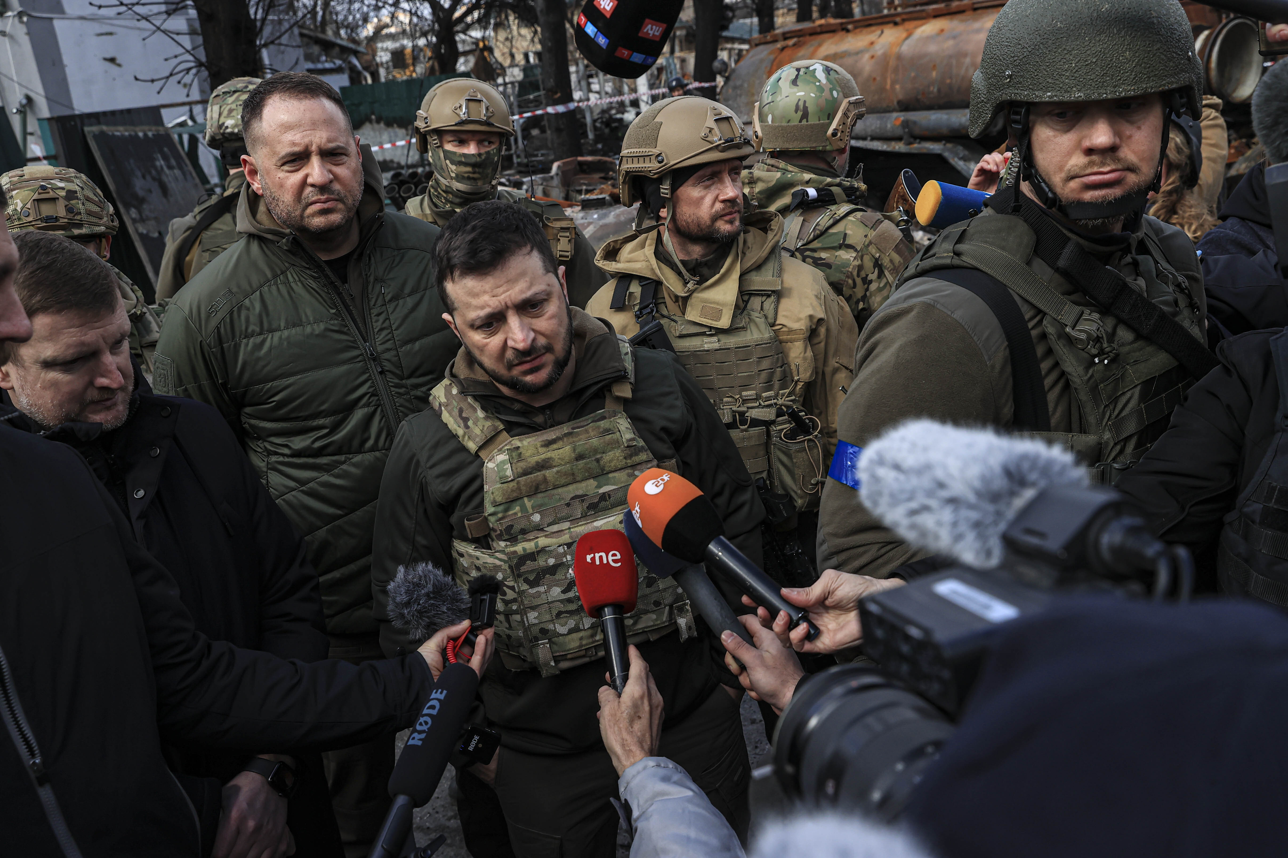 Ukrainian President Volodymyr Zelensky, accompanied by Ukrainian soldiers, speaks to the press during his visit to the town of Bucha, Ukraine, on April 4.