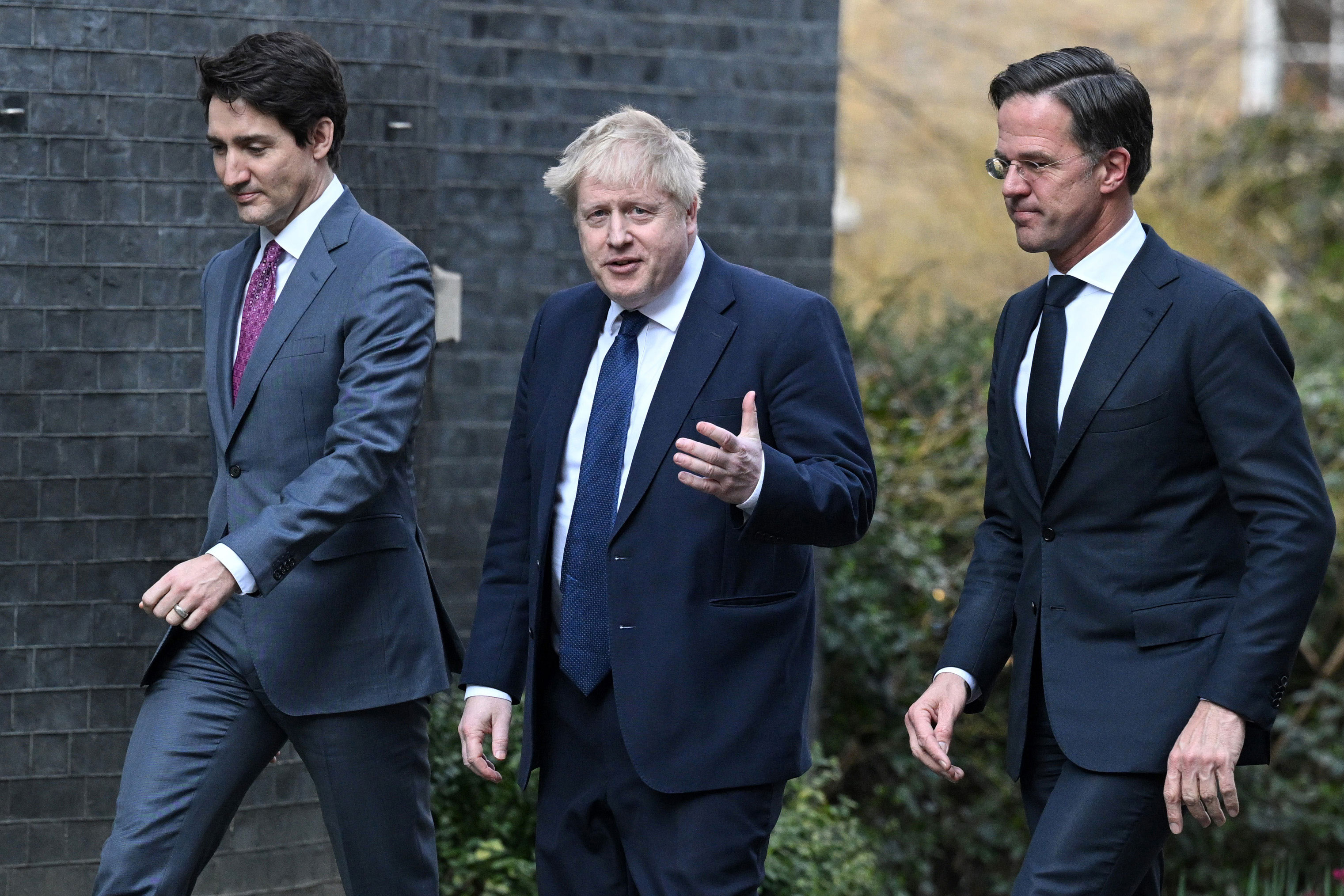 Left to right: Canada's Prime Minister Justin Trudeau, UK Prime Minister Boris Johnson, and Netherlands Prime Minister Mark Rutte walk back to 10 Downing Street in London after holding a joint press conference on March 7.