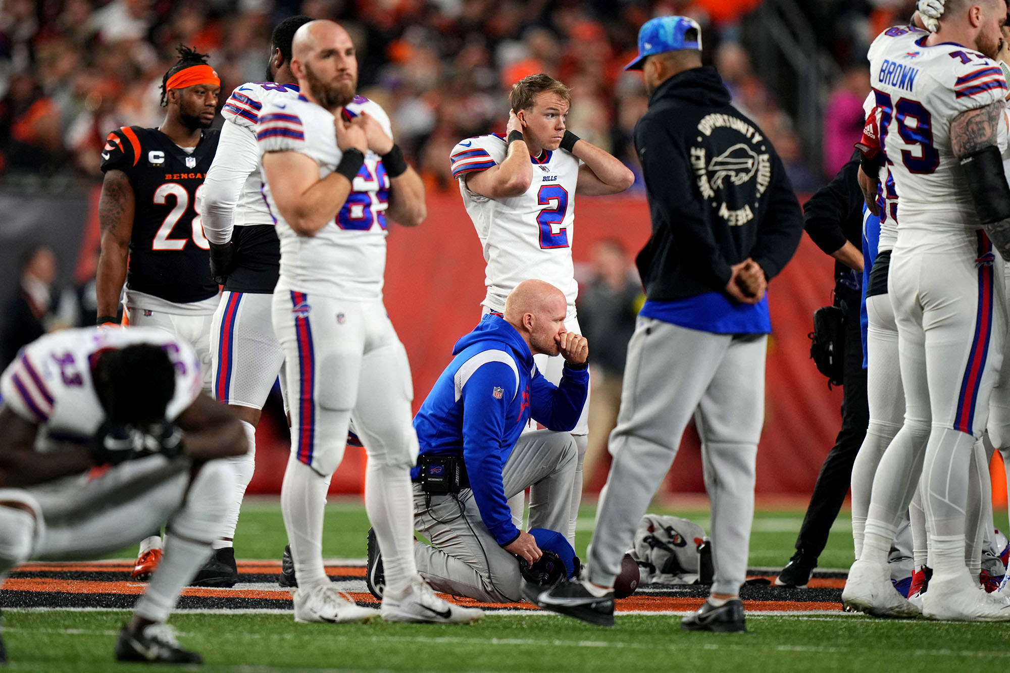 Buffalo Bills head coach Sean McDermott takes a knee as Buffalo Bills safety Damar Hamlin is tended to on the field following a collision in the first quarter against the Cincinnati Bengals at Paycor Stadium on January 2 in Cincinnati, Ohio.