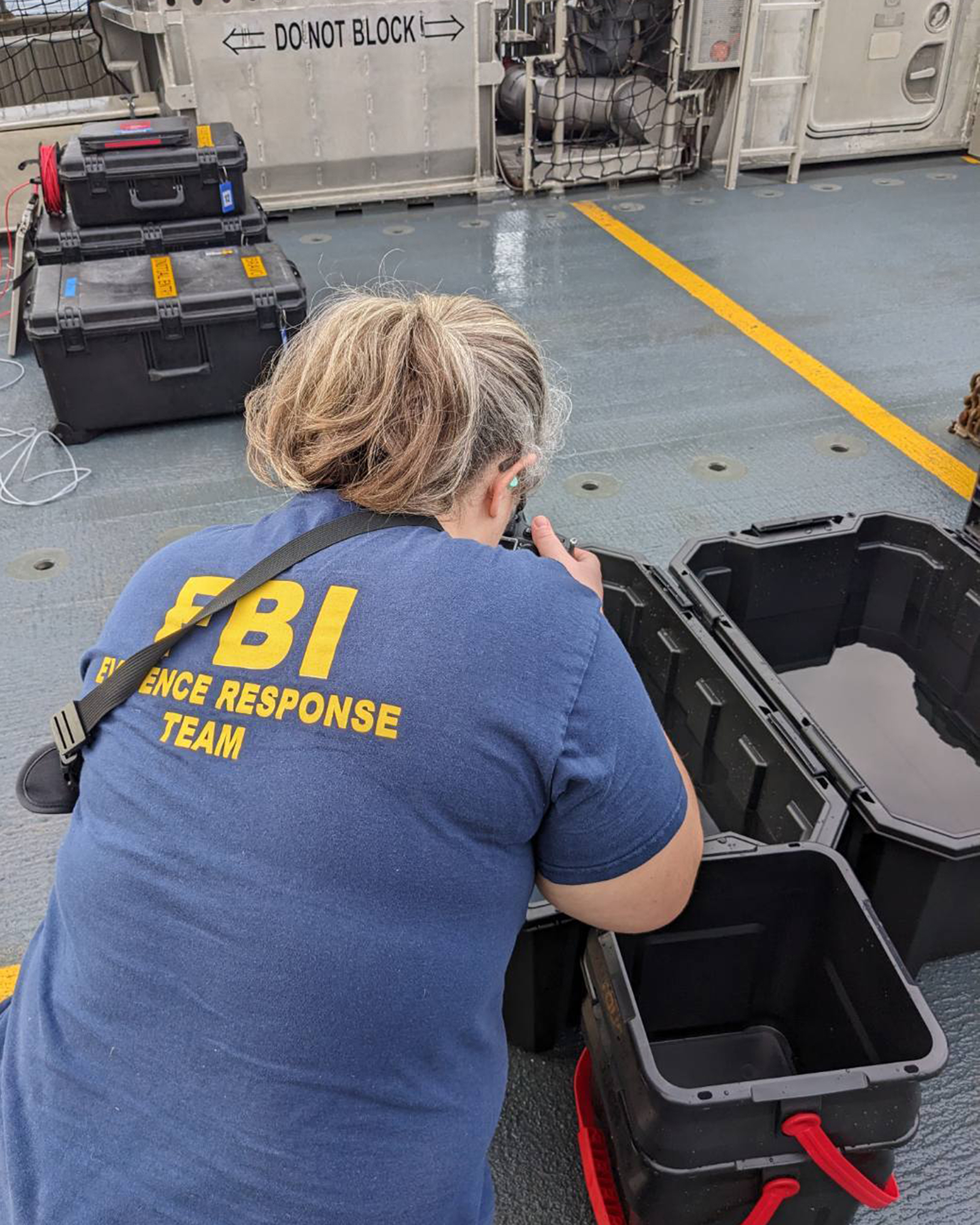 An FBI Evidence Response Team Photographer captures images of recovered material.