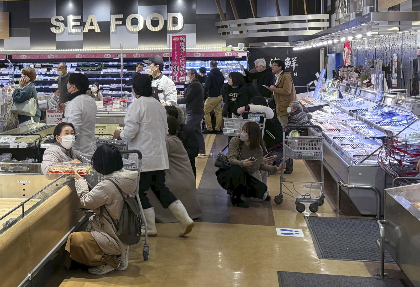 Shoppers crouch inside a supermarket following the earthquake in Toyama, Japan. 