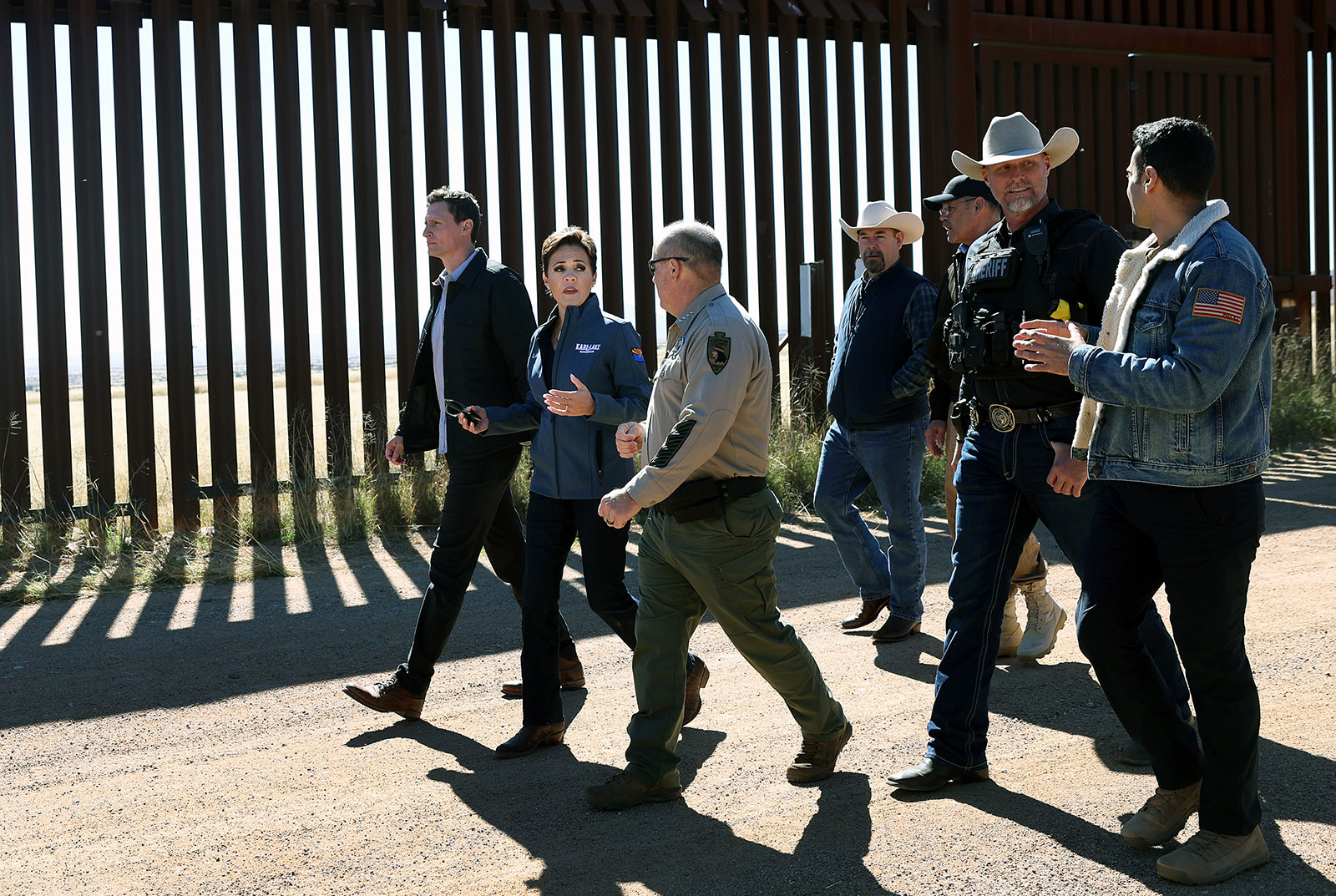 Blake Masters, Kari Lake, Mark Finchem and Abraham Hamadeh walk with Cochise County Sheriff Mark Dannels and other law enforcement along the US-Mexico border in Sierra Vista, Arizona. 