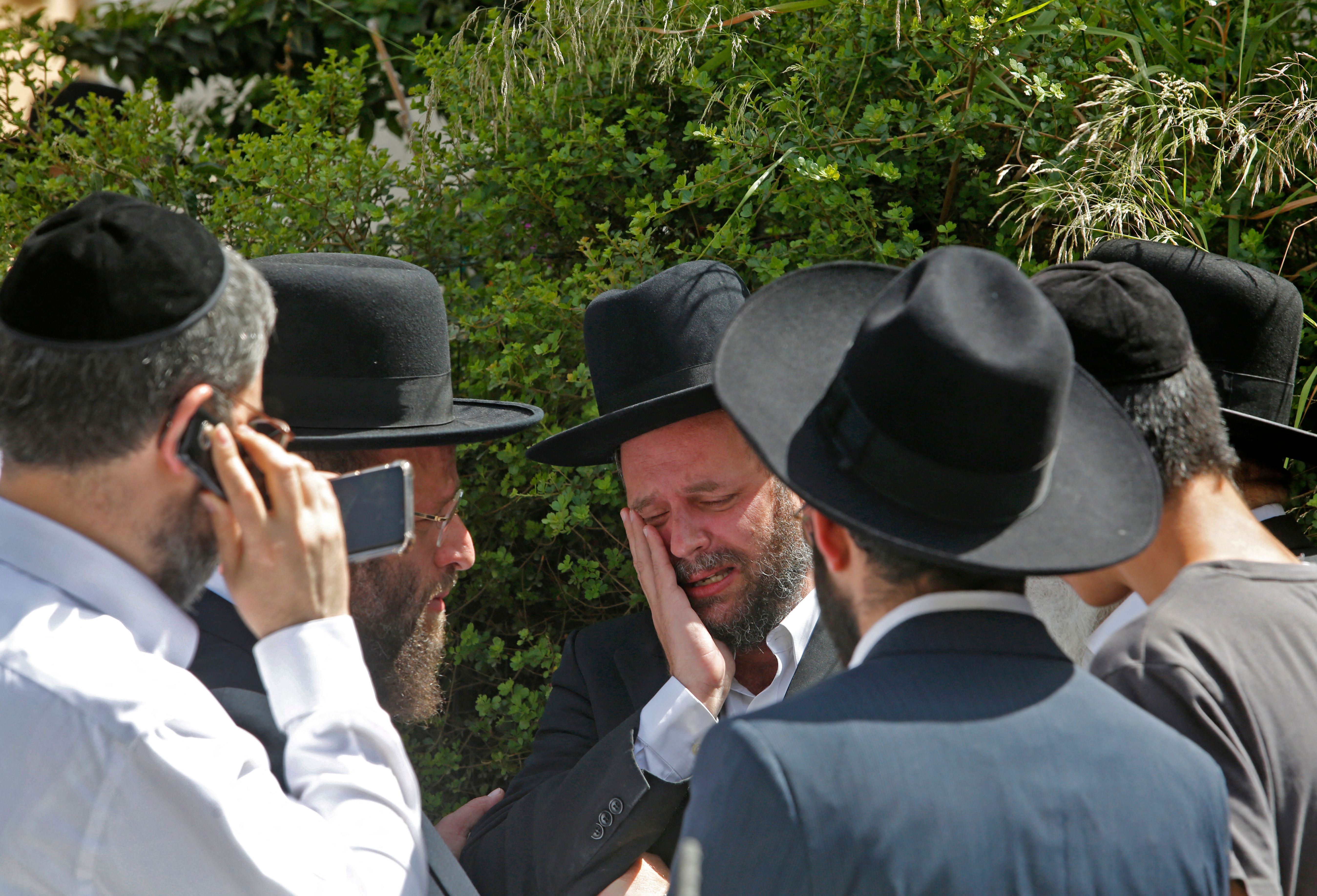 A person cries at a cemetery in Bnei Brak, Israel, on April 30 at the funeral for one of the victims of the Lag B'Omer stampede.