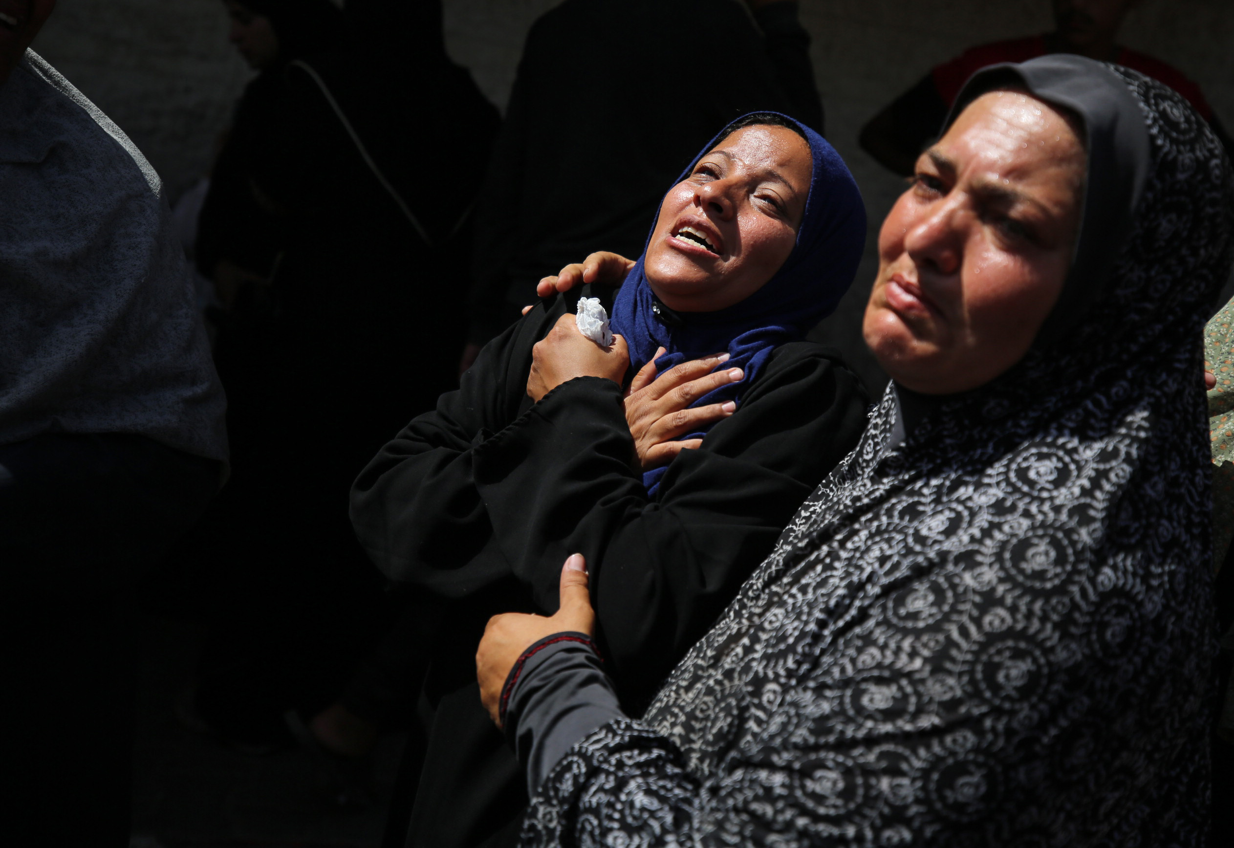 Palestinian women mourn the deaths of loved ones in Deir al-Balah, Gaza, on June 8. 