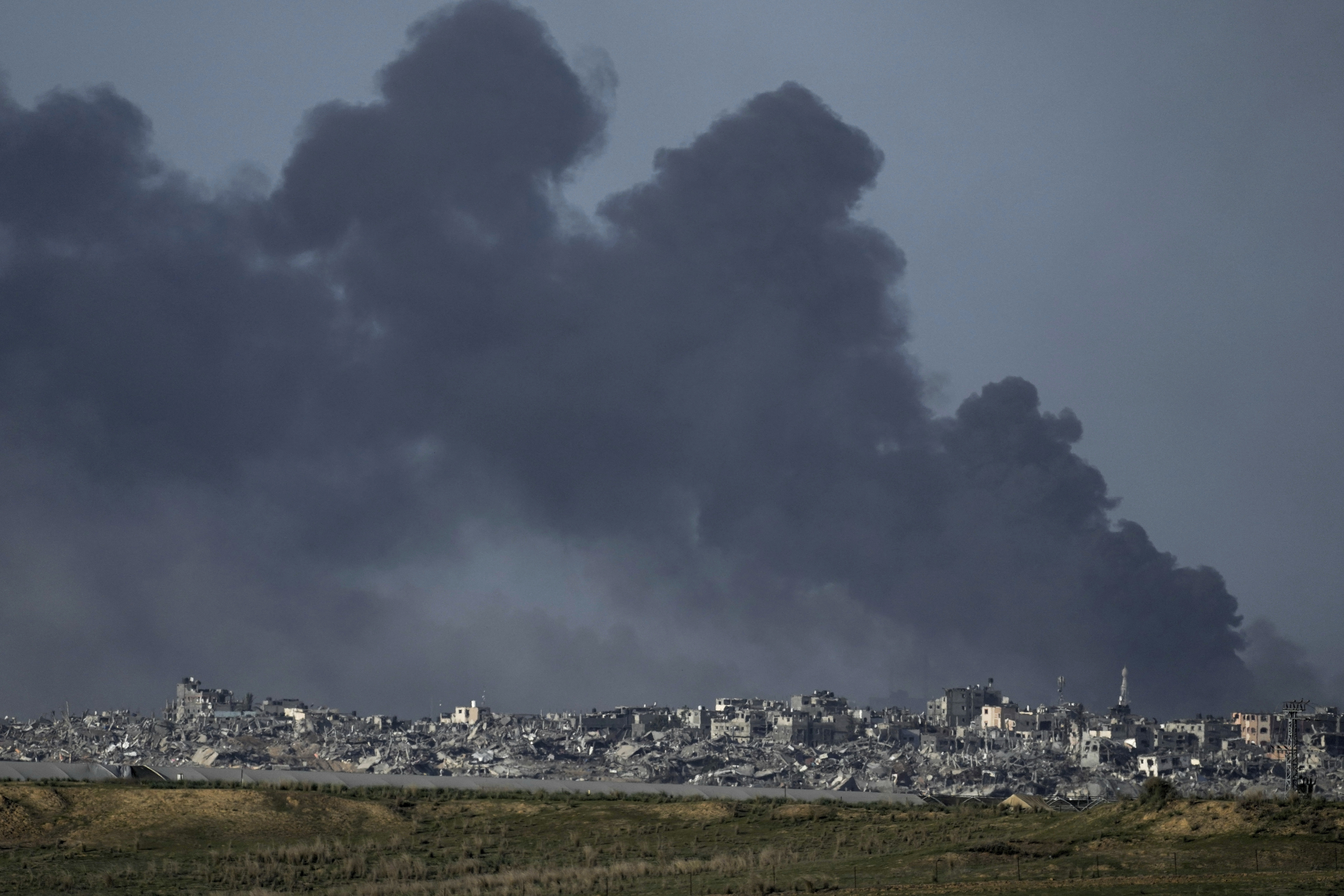 Smoke rises following an Israeli bombardment in Gaza, as seen from southern Israel, on December 26.