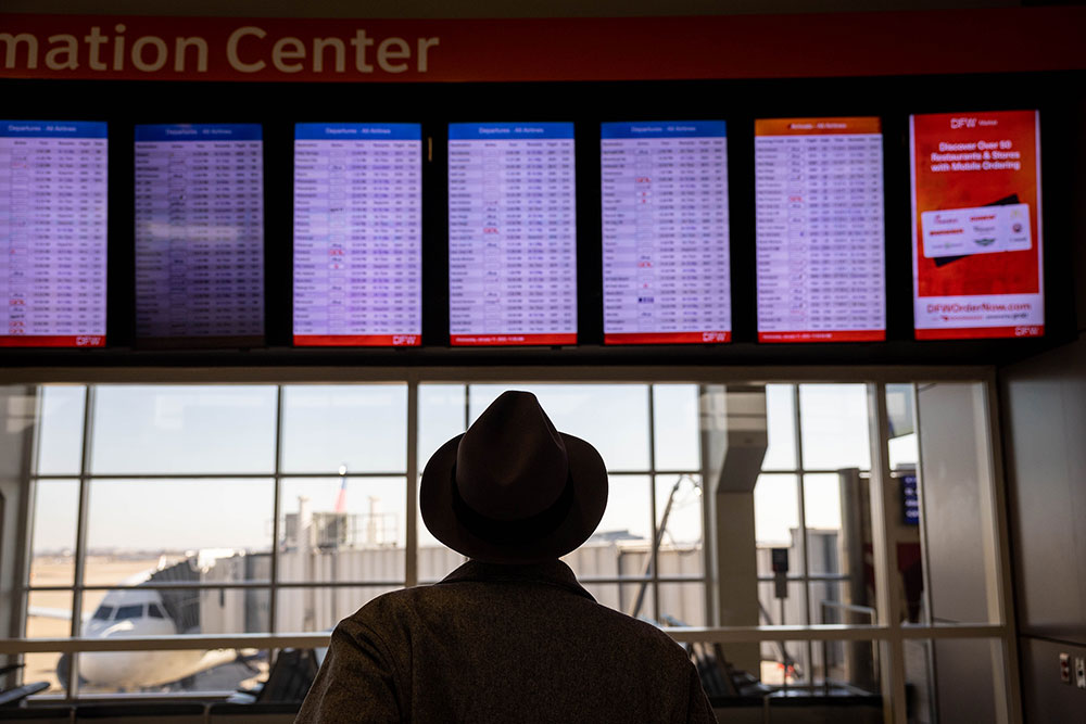 A passengers checks a flight board at Dallas-Fort Worth International Airport on Wednesday, January 11.