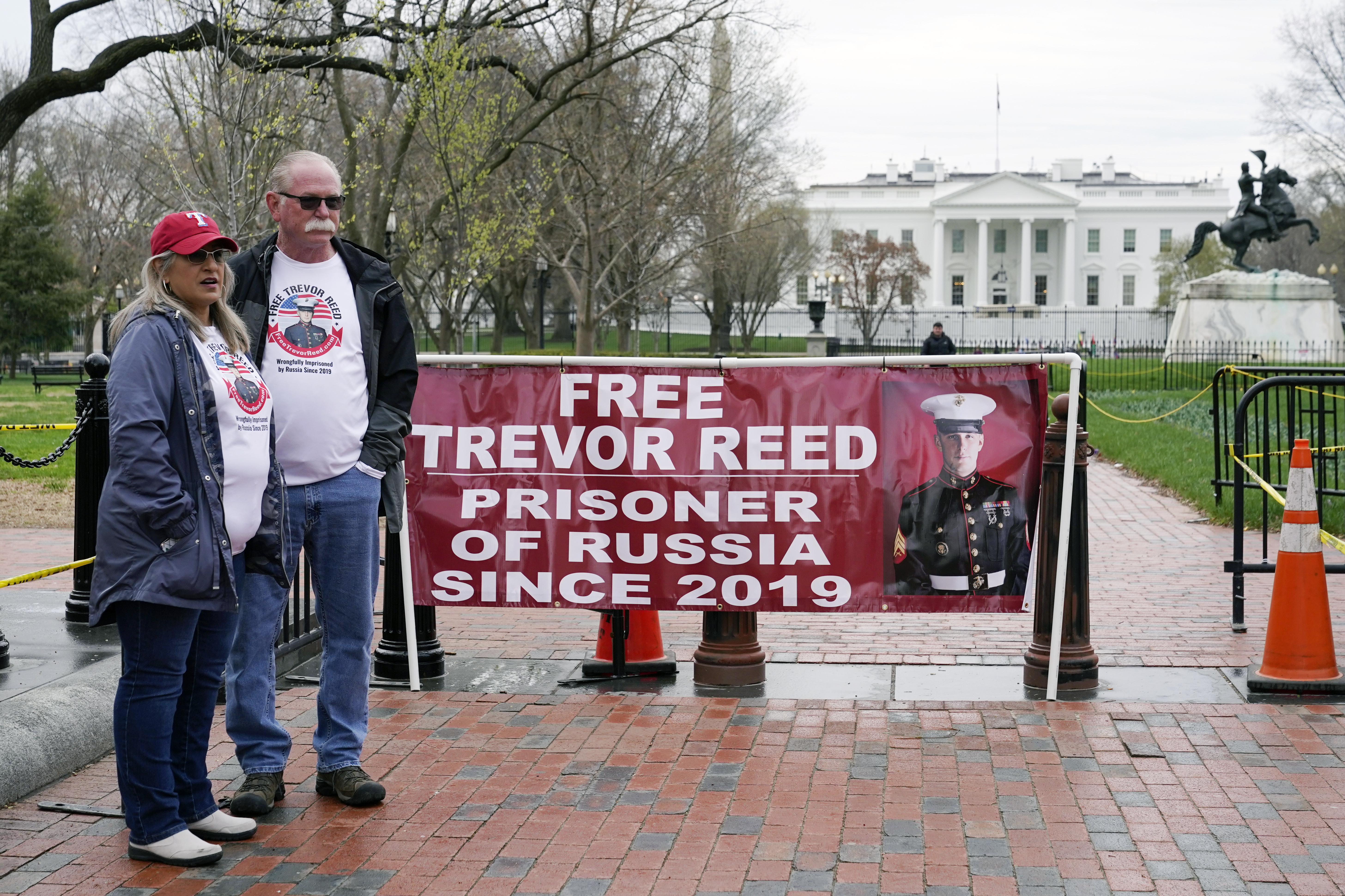 Joey and Paula Reed, parents of U.S. Marine Corps veteran and Russian prisoner Trevor Reed, stand in Lafayette Park near the White House on Wednesday, March 30.