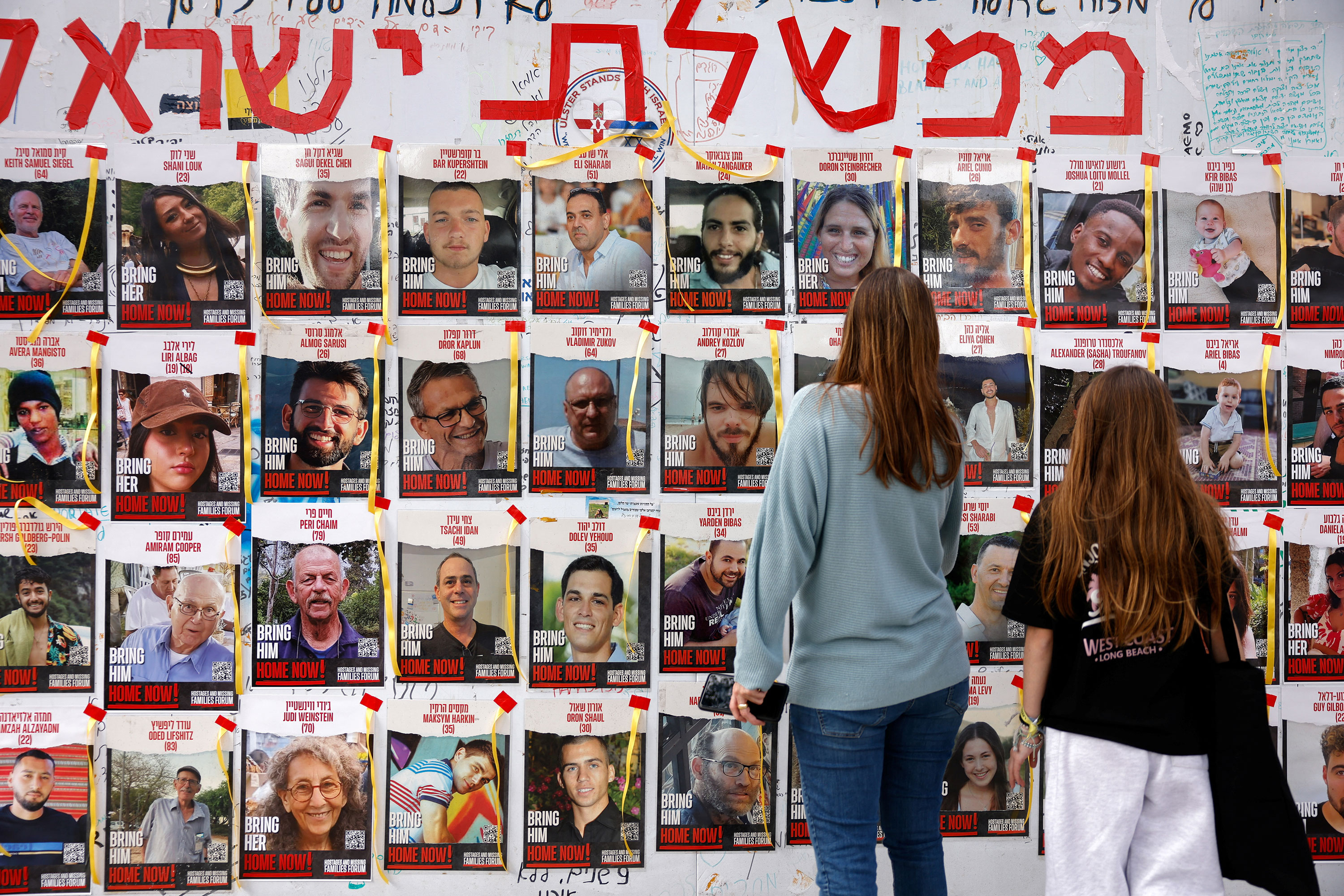 People look at posters with photos of hostages in Tel Aviv, Israel, on March 8. 