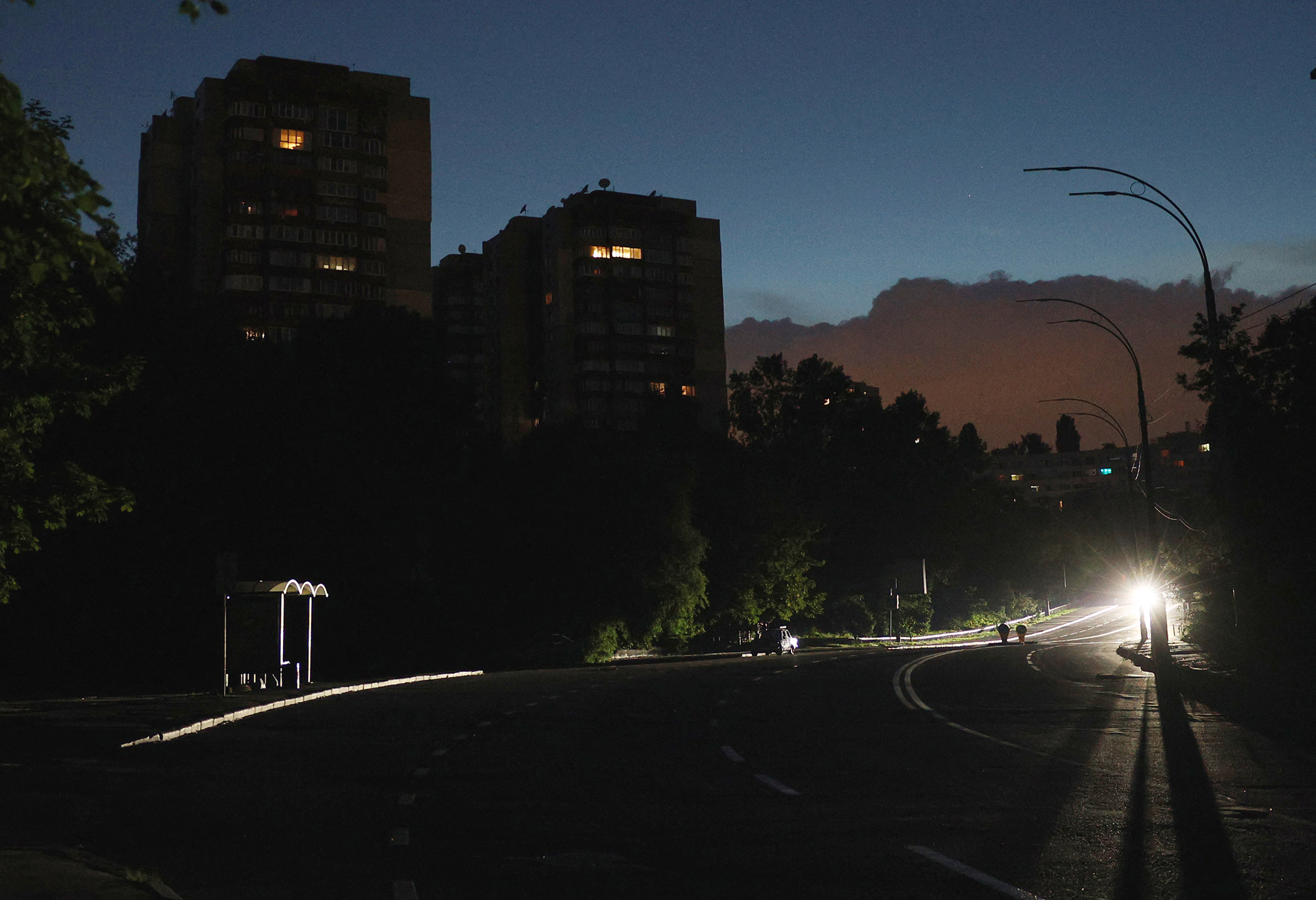 A car driving on a dark street during a partial electricity blackout in Kyiv, Ukraine, on June 5.