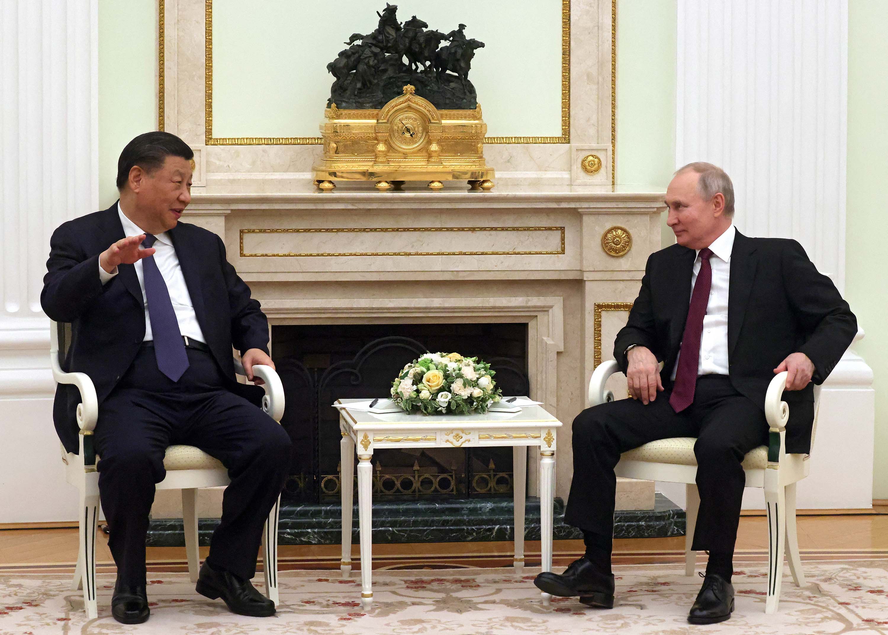 China's President Xi Jinping talks with Russian President Vladimir Putin at the Kremlin in Moscow, on Monday, March 20. 