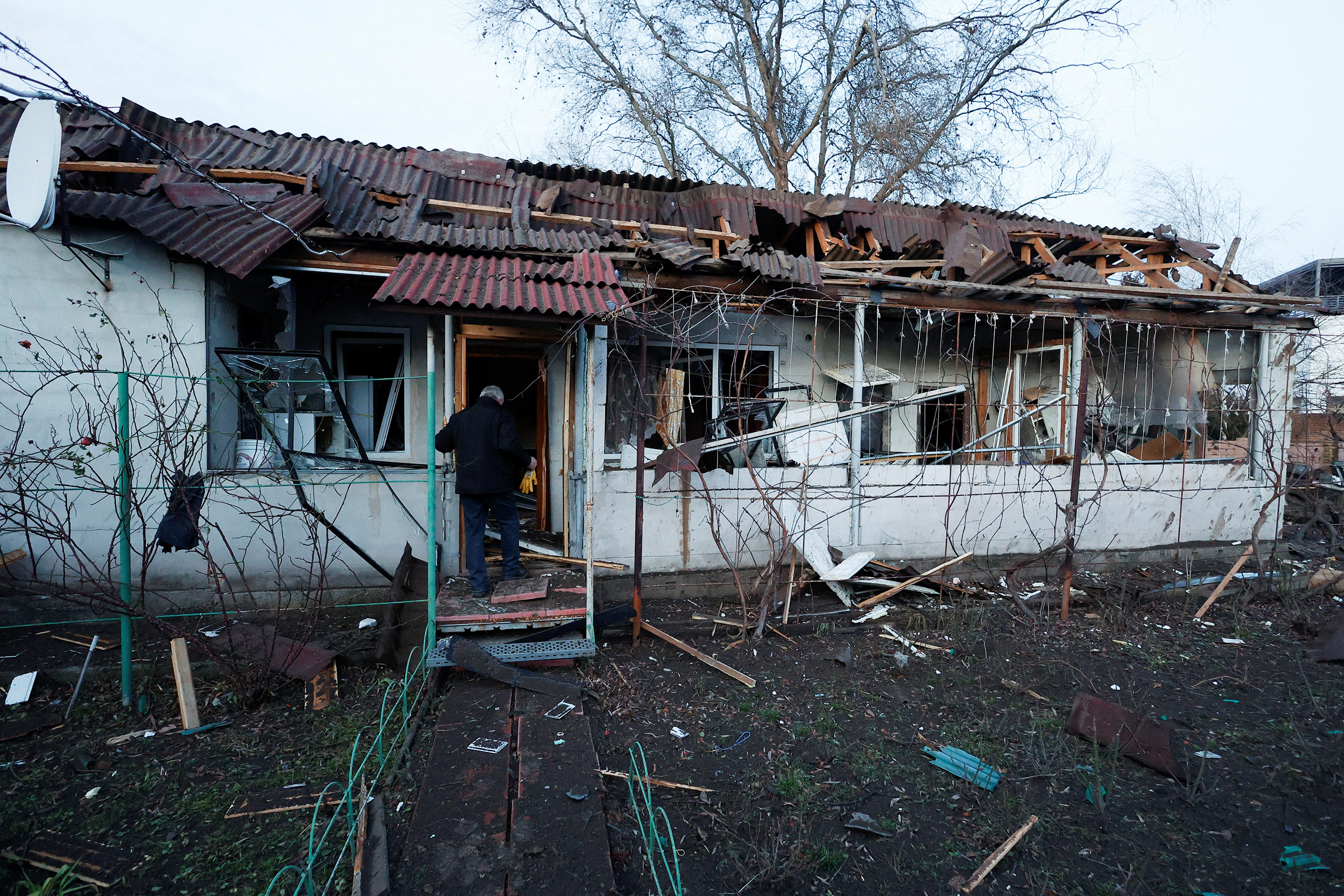 A resident walks into his house after a Russian missile strike in Kyiv, Ukraine, on December 31. 