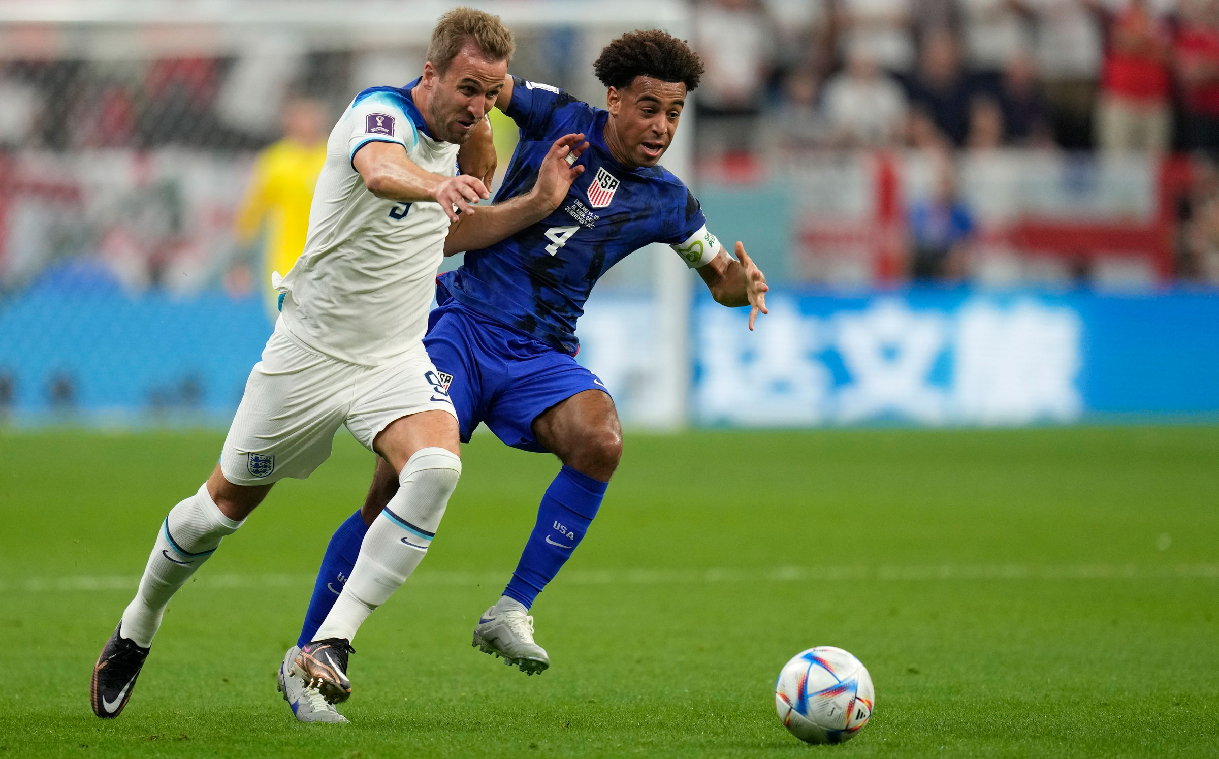 England's Harry Kane, left, is challenged by US midfielder Tyler Adams.