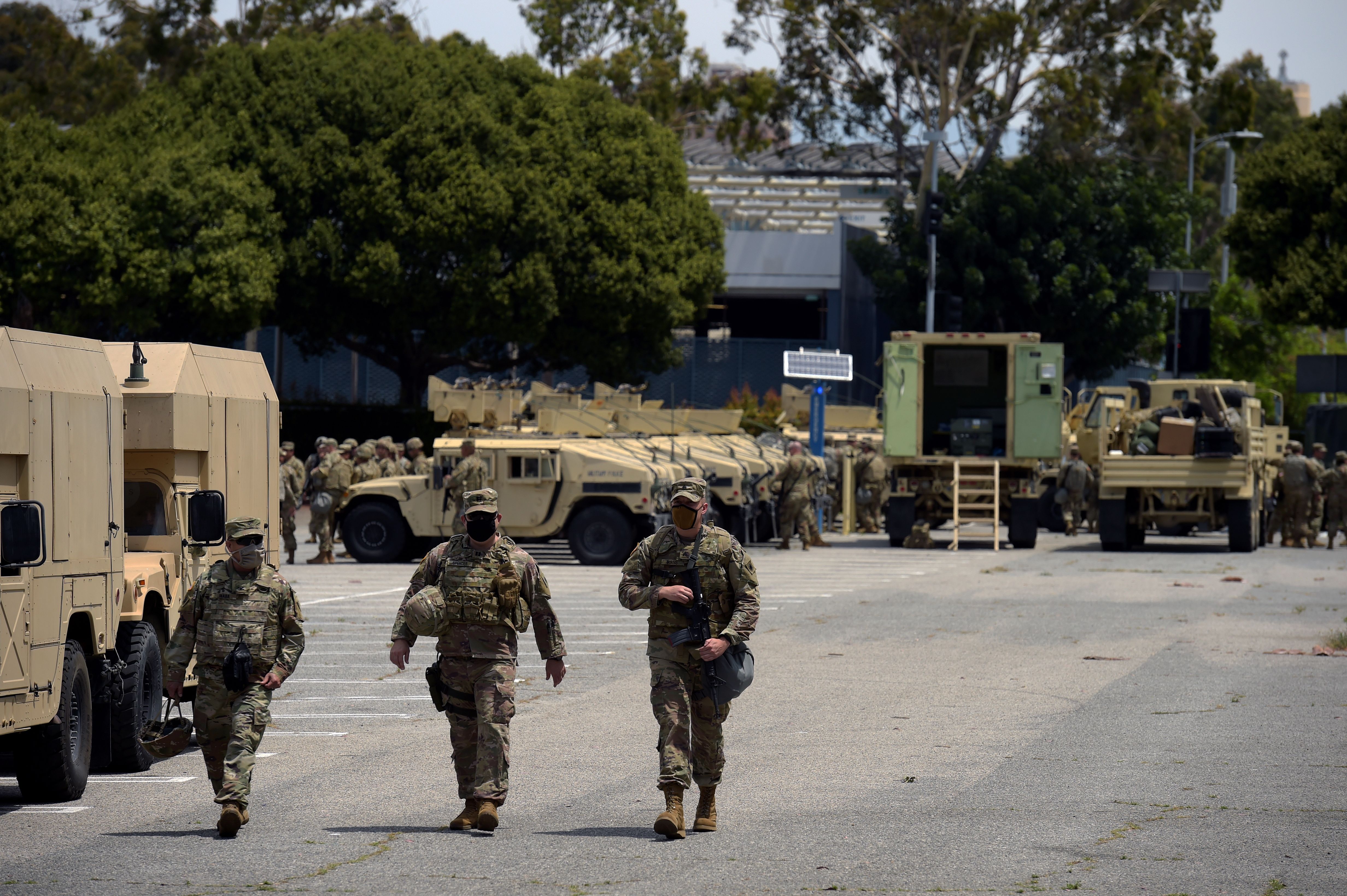 California National Guard soldiers walk in a parking lot after people protested in Los Angeles on May 31.