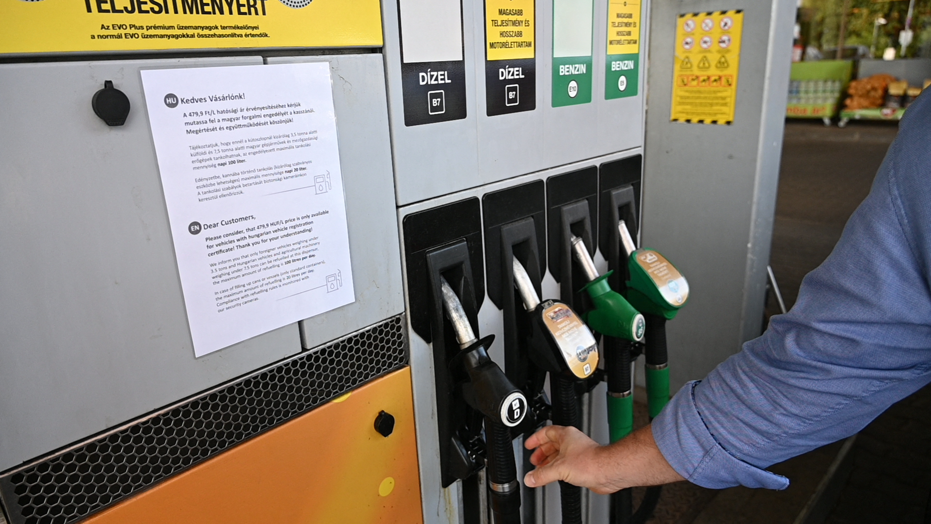 A notice stating the Hungarian government's ruling that cars with Hungarian tags may buy fuel at government-capped prices, while cars with foreign number plates will have to pay market prices,  at a gas station in Budapest, Hungary on May 27,  