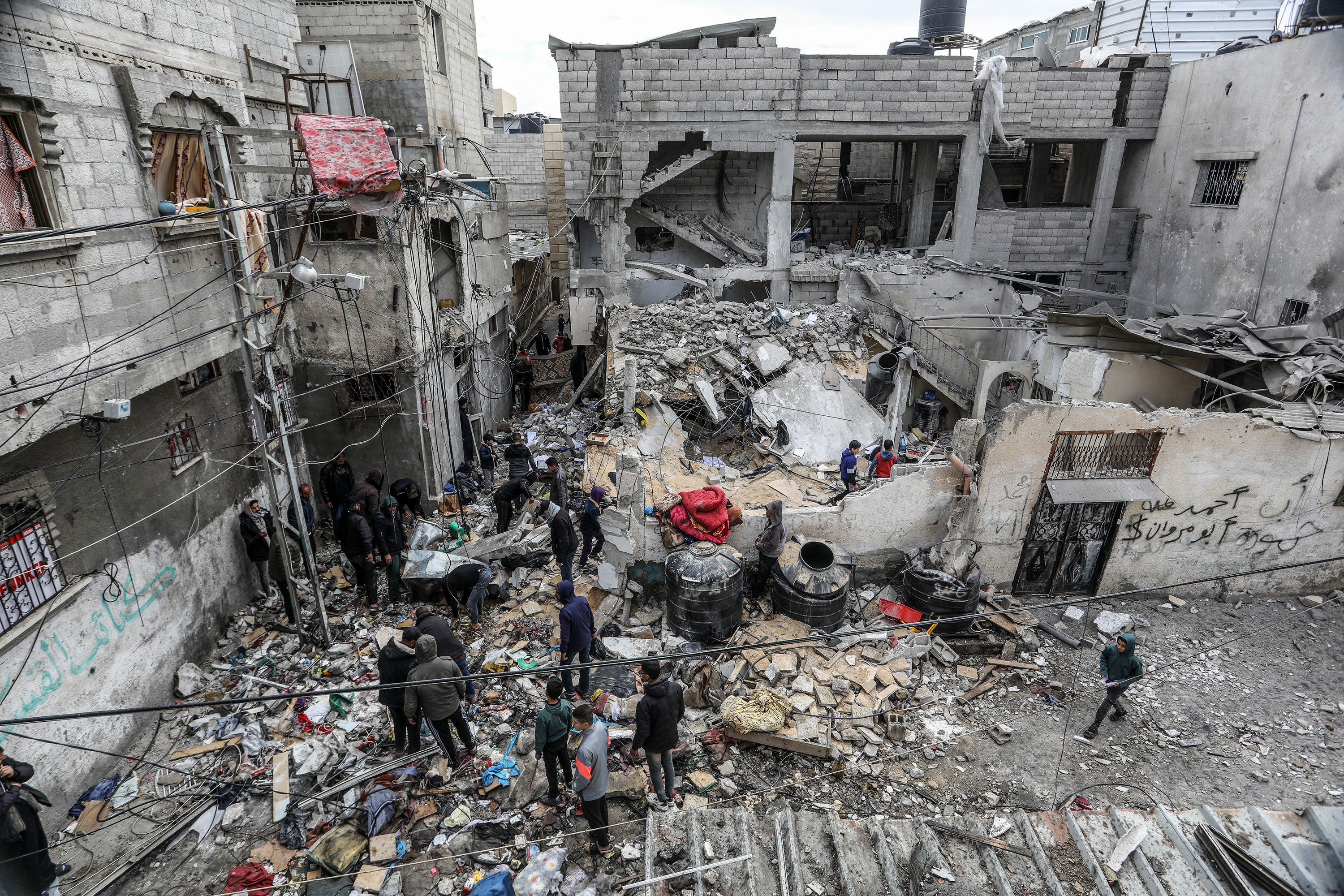 Palestinians residents examines the rubbles of destroyed buildings following Israeli attacks in Rafah, Gaza on February 16.