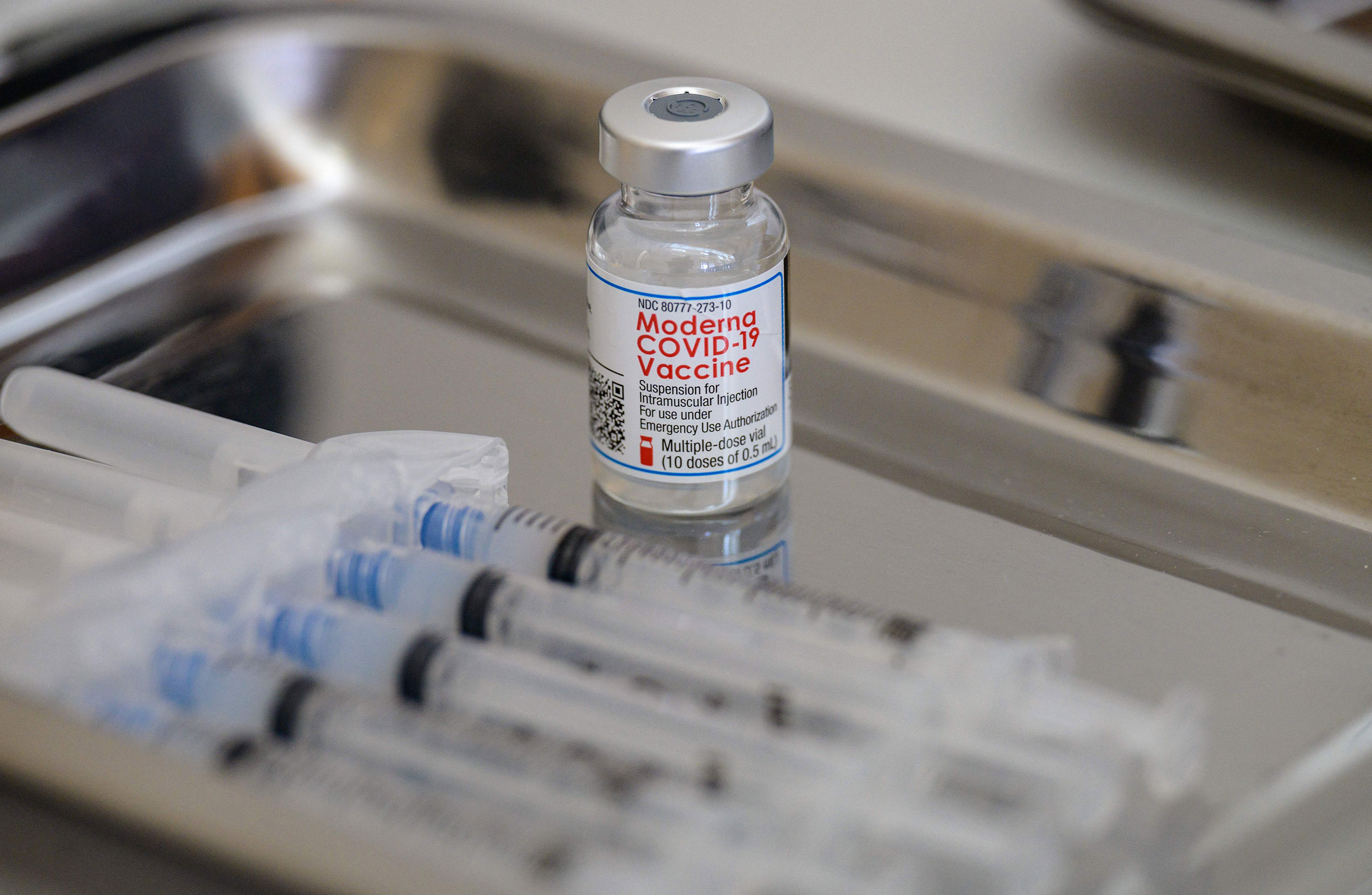 A vial of the Moderna Covid-19 vaccine and syringes are prepared at a pop-up vaccine clinic in Staten Island, New York, on April 16.