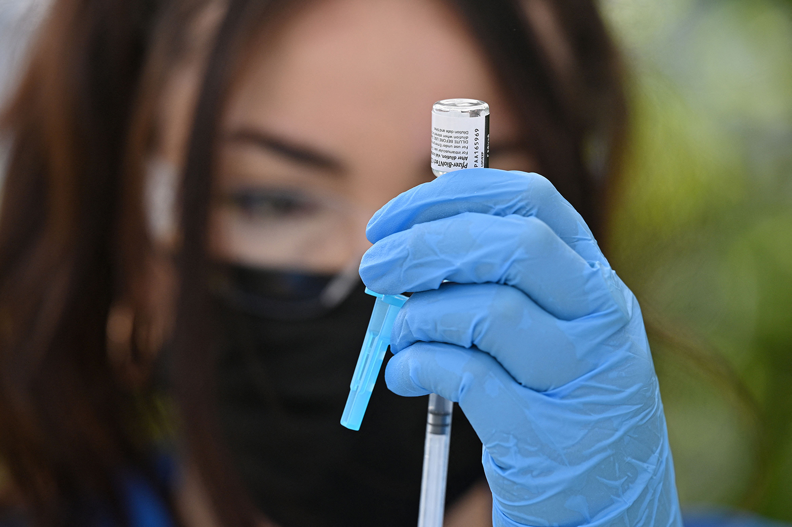 A healthcare worker fills a syringe with Pfizer Covid-19 vaccine at a community vaccination event in Los Angeles on August 11.
