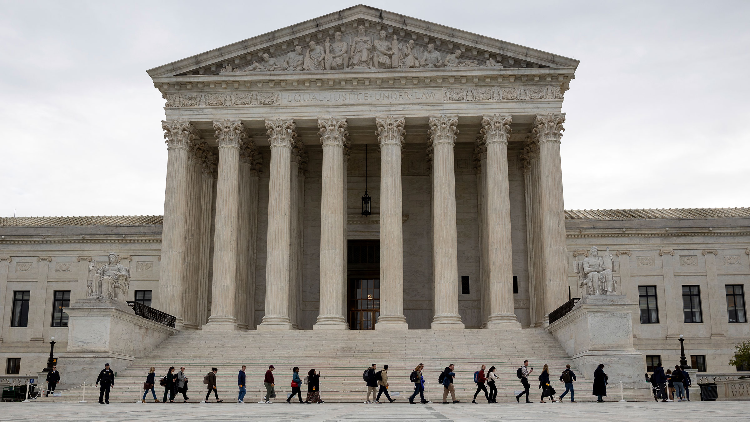 Members of the public enter the Supreme Court to attend oral arguments on Monday.
