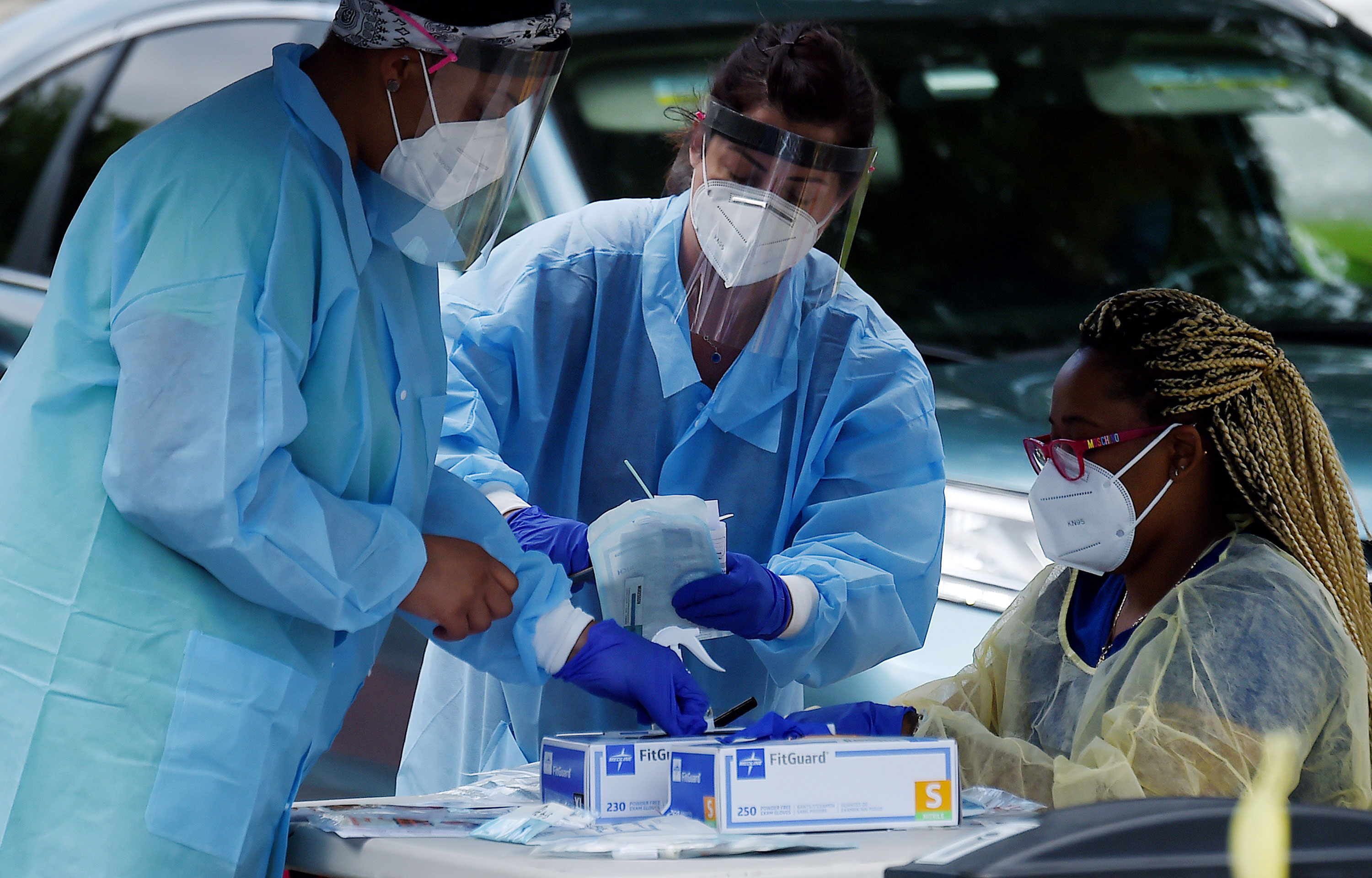 Health workers prepare to give people free coronavirus tests at a testing center in Arlington, Virginia, on May 26.