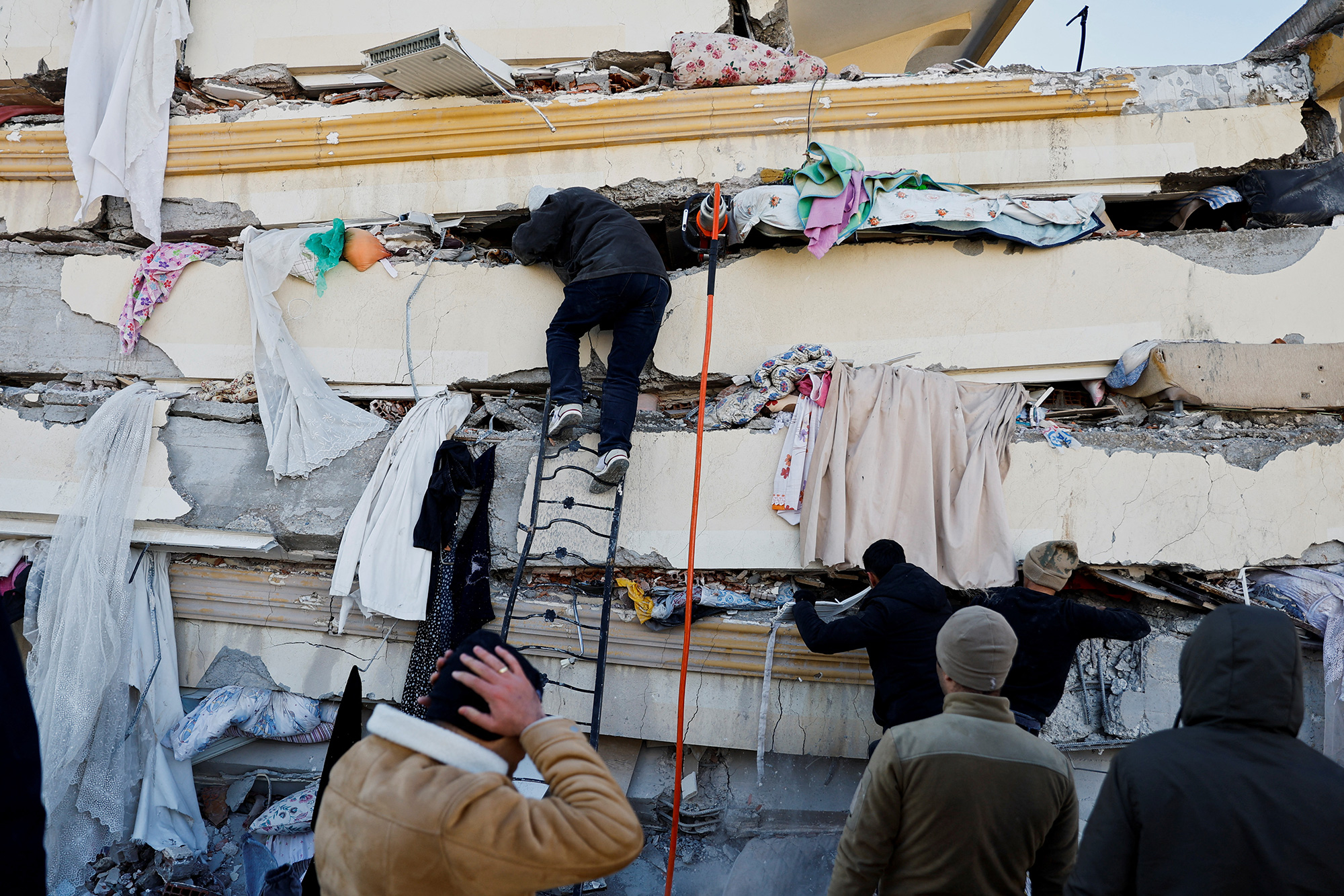 People search in the rubble at the site of a collapsed building following an earthquake in Kahramanmaras, Turkey, on February 7.