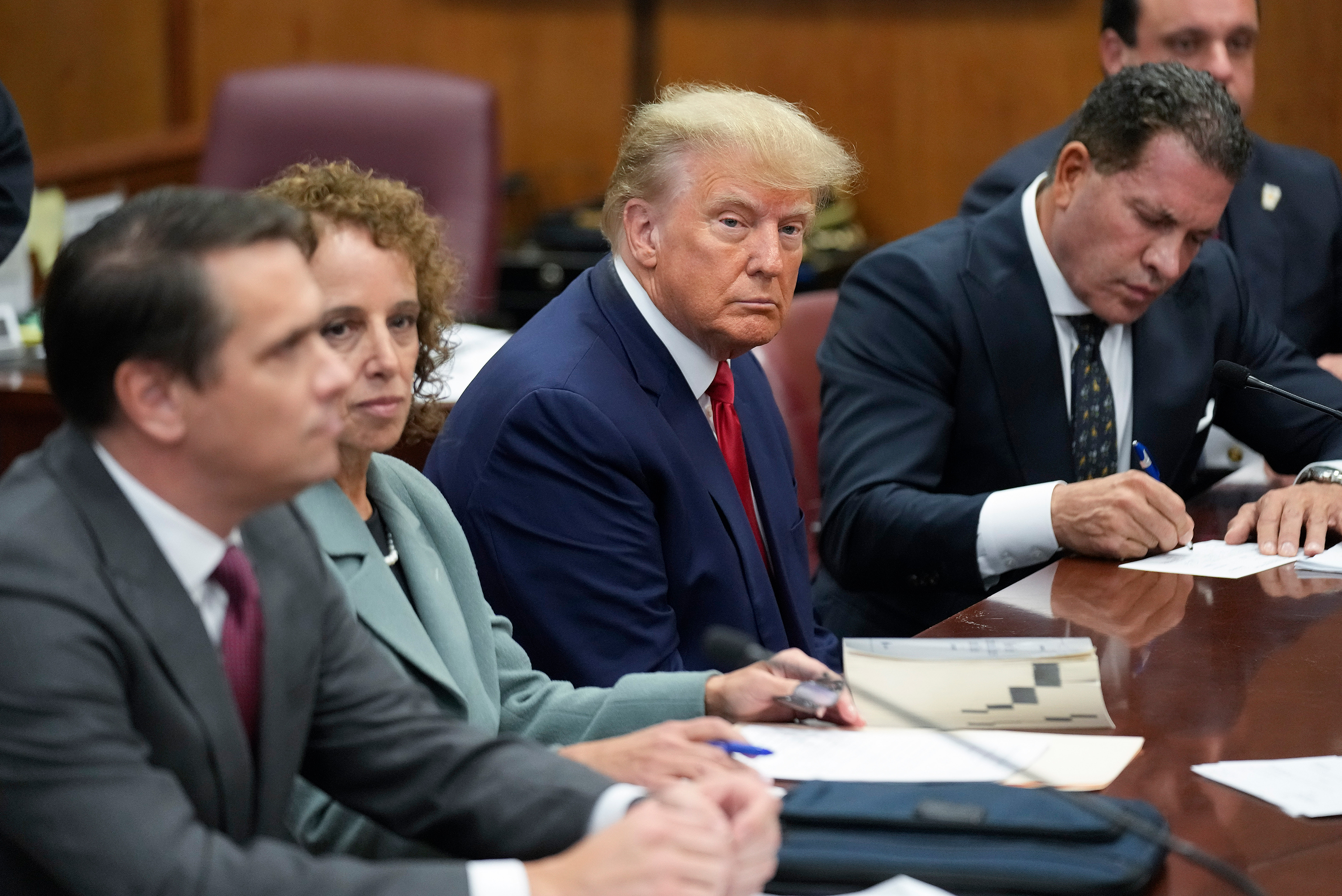 Former President Donald Trump sits at the defense table with his defense team in a Manhattan court, Tuesday, April 4, 2023, in New York. 