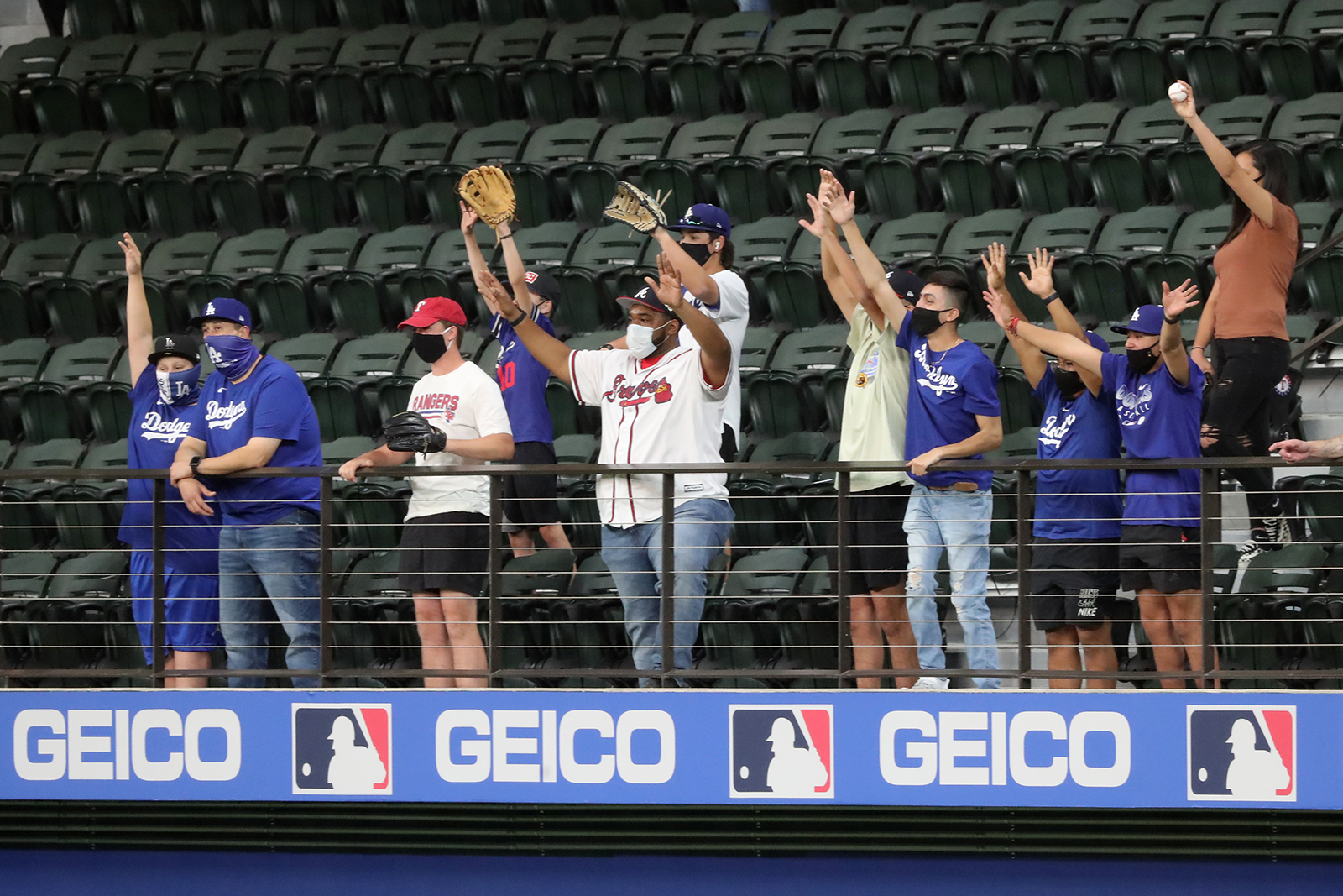 Atlanta Braves fans and Los Angeles Dodgers fans cheer during batting practice before Game 1 for the best-of-seven National League Championship Series at Globe Life Field in Arlington, Texas, on October 12.