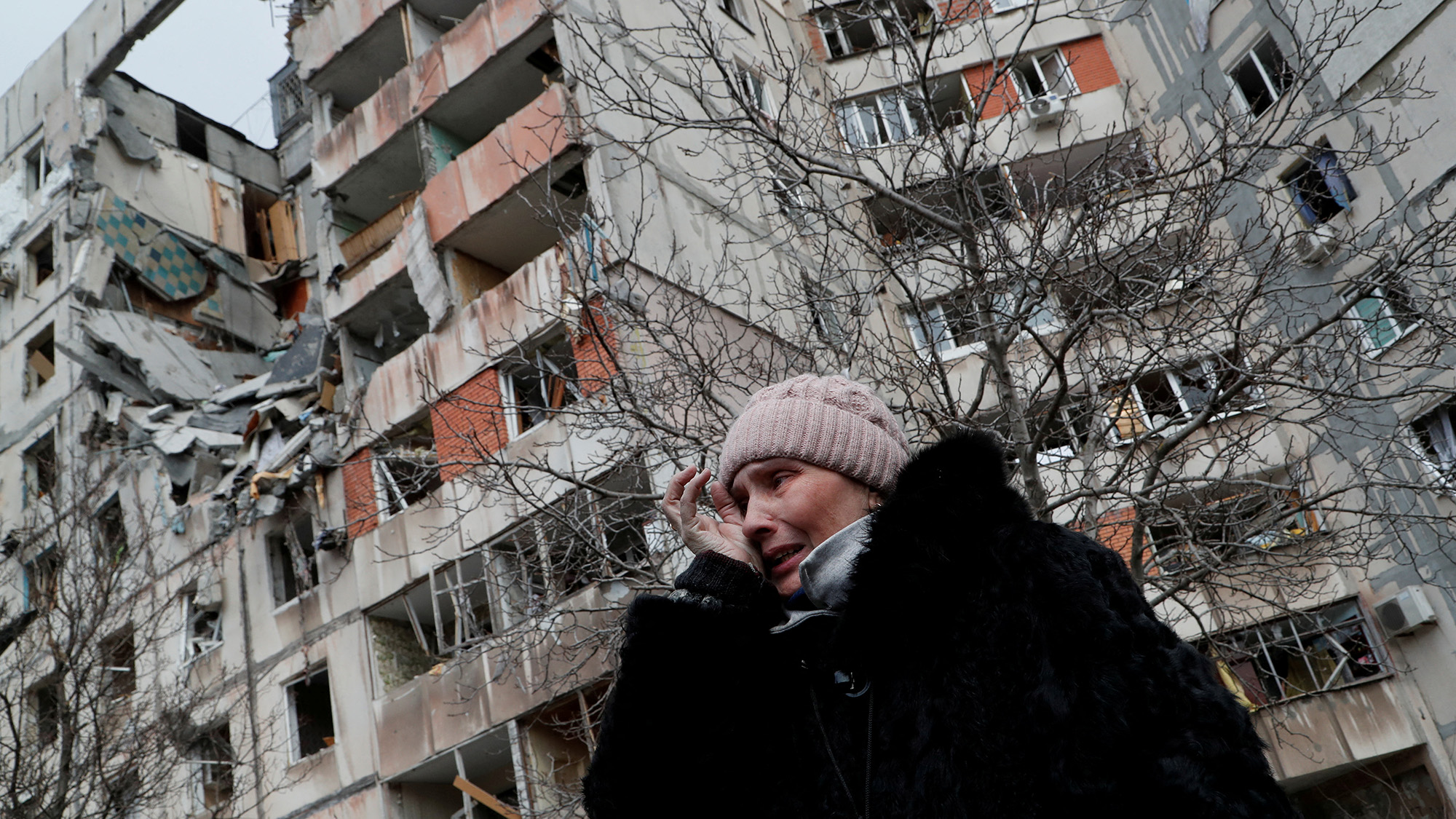 A woman reacts while speaking near a block of destroyed apartment buildings in the besieged southern port city of Mariupol, Ukraine March 17.