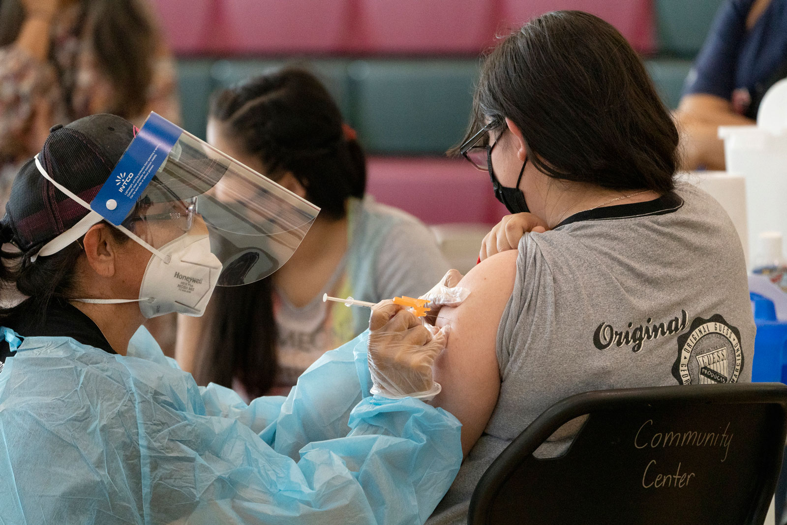 A teenager from East Los Angeles receives the Covid-19 vaccine at the Esteban E. Torres High School in Los Angeles on May 27.