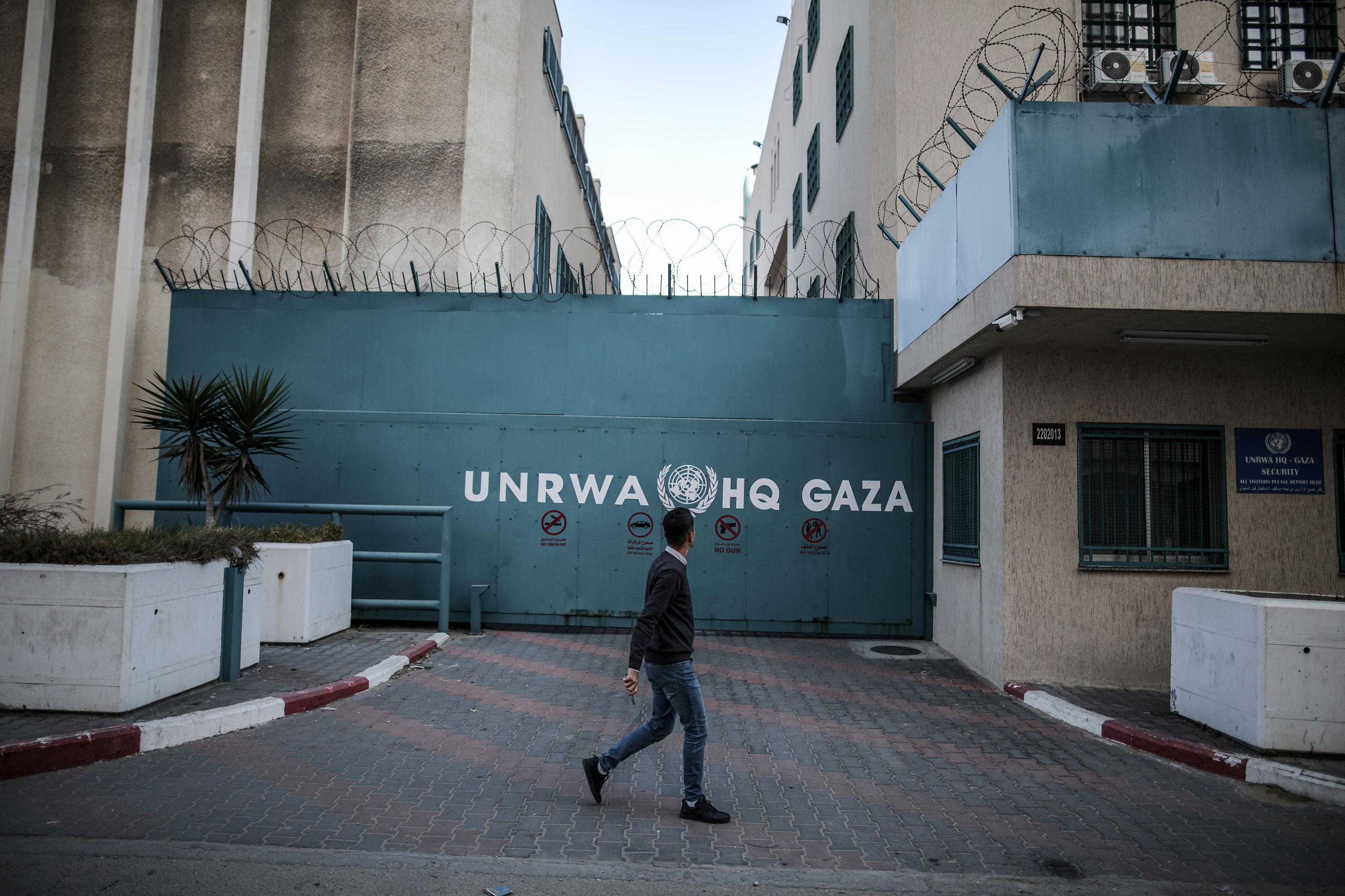 A man walks past the United Nations Relief and Works Agency building in Gaza City in January 2023.