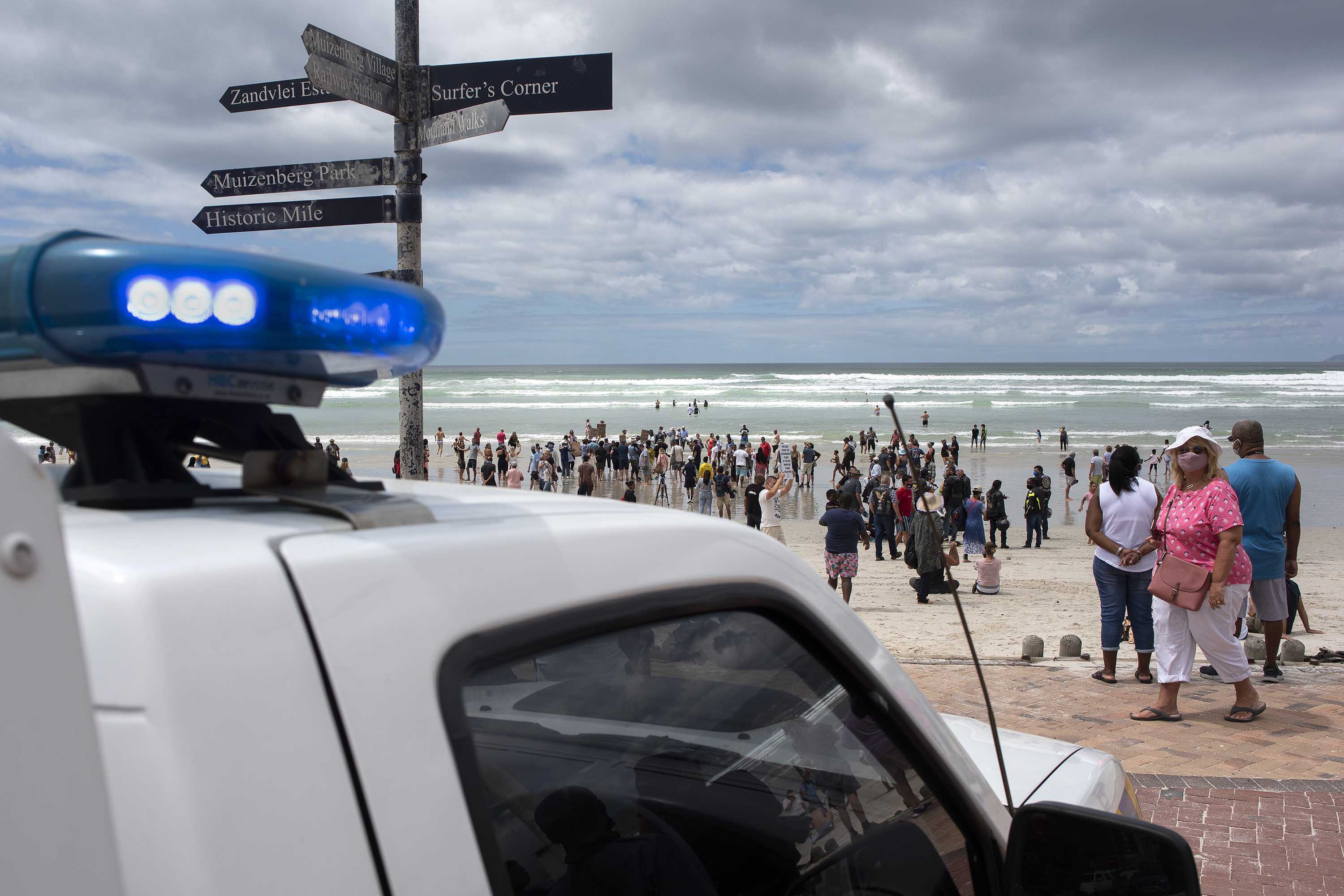 A law enforcement vehicle is seen as people protested against the government's ban on beach access in Cape Town's Muizenberg district, on January 30. 