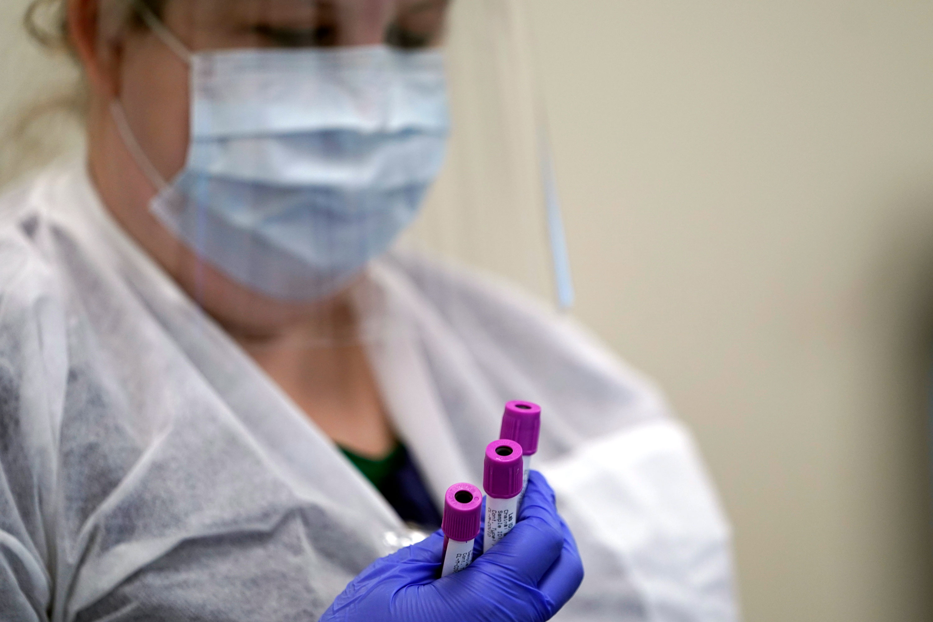 Julie Janke, a medical technologist at Principle Health Systems and SynerGene Laboratory, holds blood samples to be tested for COVID-19 antibodies on April 28 in Houston. 